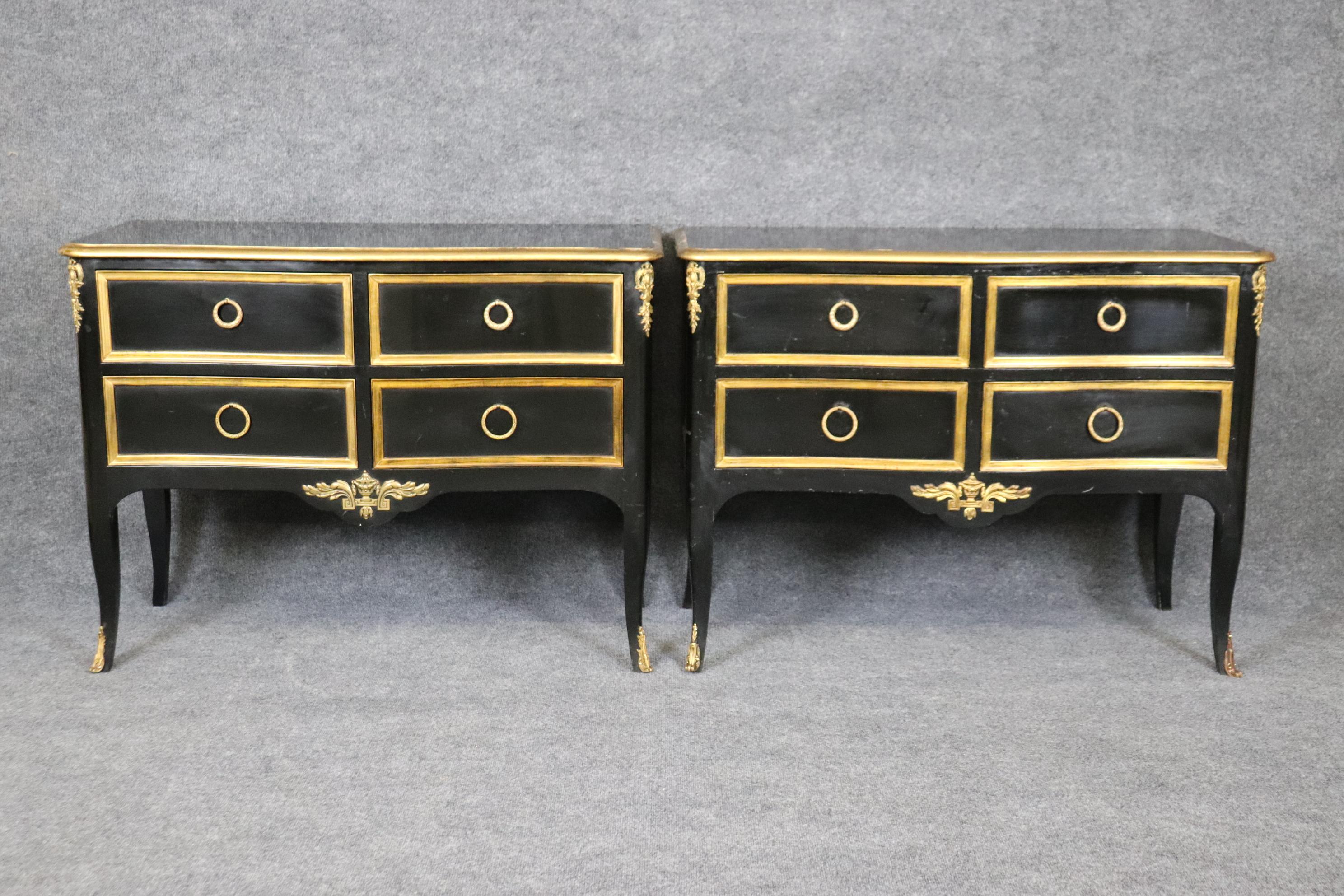 These gorgeous commodes are made of oak and walnut and lacquered in black lacquer and genuine time-worn gold leaf. The commodes were designed in the manner of Maison Jansen of Paris but made in the USA by Jacques Bodart. He made many fine French