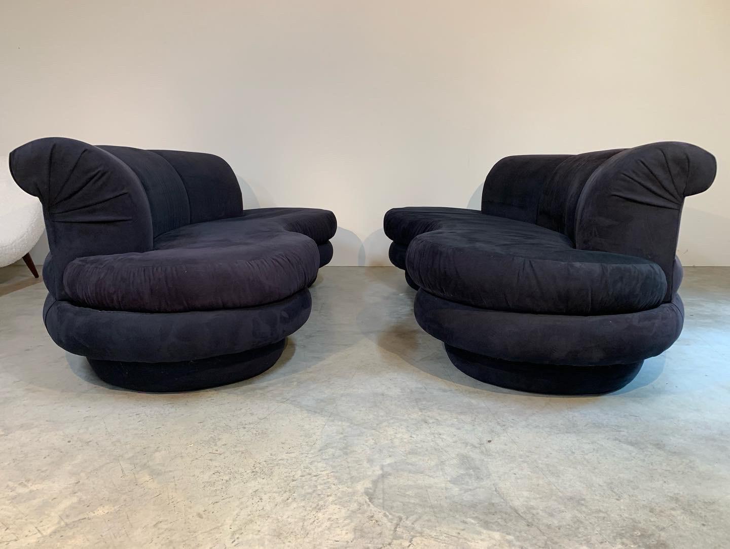 A gorgeous pair of apposing kidney sofas attributed to Kagan for Directional having deep blue Ultrasuede upholstery. Excellent form and incredibly comfortable. Price is for the pair! 
Great overall condition on both sofas. The original owner