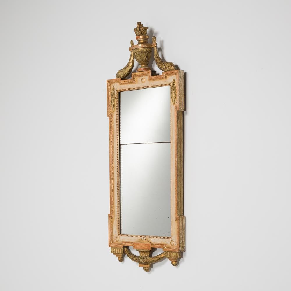 Matched pair of Swedish Gustavian gilt and painted framed mirrors with finials depicting urns and fauna and swag to the bottom of the frame, circa 1780 original giltwood frames with split level mercurial mirrors plates.