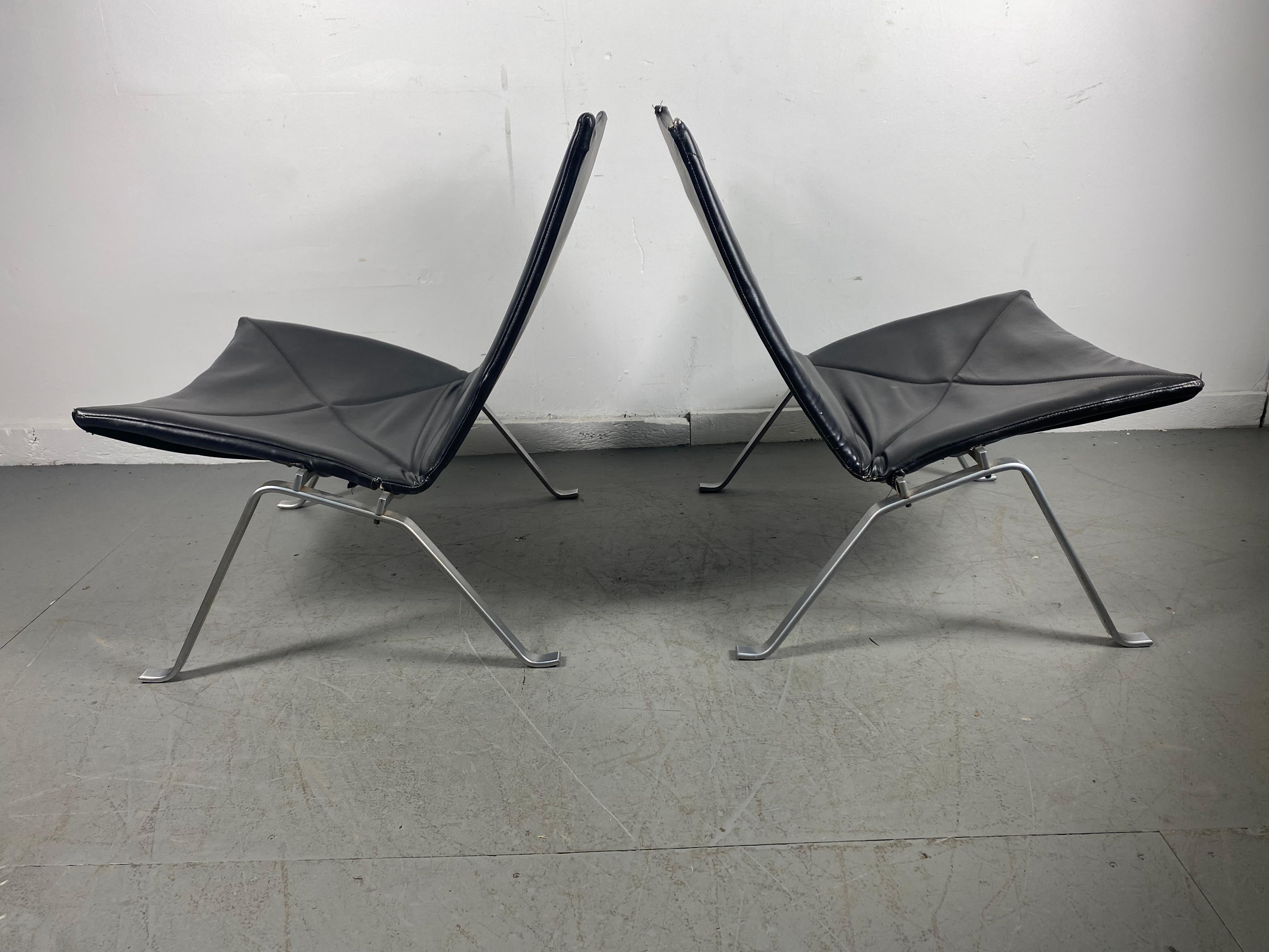 Matched pair early PK22 lounge chairs by Poul Kjærholm for E Kold Christensen.. retain original black naugahyde, one chair top corners in need or repair (see photo),
E. Kold Christensen edition, the matte chrome frame embossed with EKC logo