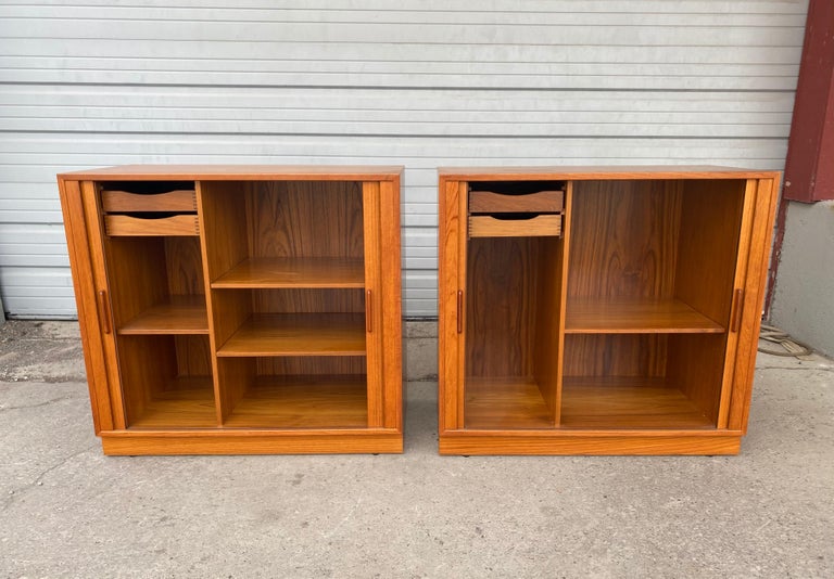 Classic pair Danish teak cabinets, servers with tambour doors, Superior quality and construction. Dove-tail interior drawers, minor staining to top. (see photo) hand delivery avail to New York City or anywhere en route from Buffalo NY.