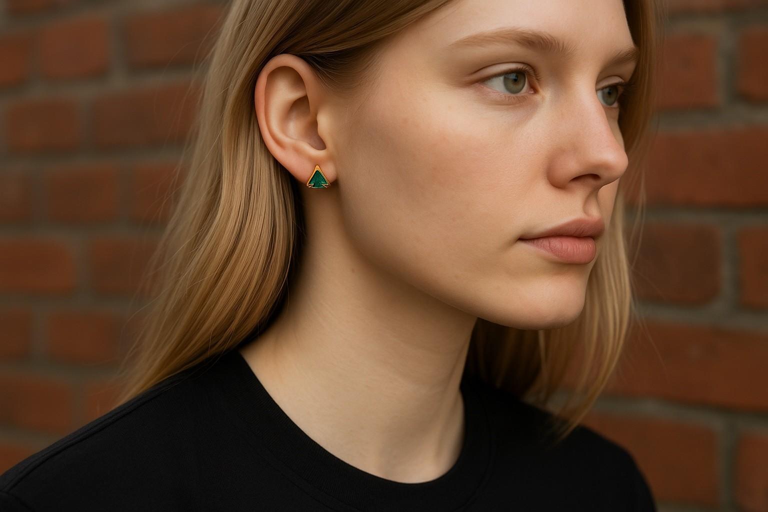 Introducing our exquisite Matched Pair Trillion Emerald Stud Earrings, a stunning addition to your jewelry collection. Crafted with precision and care, these earrings boast a perfect balance of elegance and sophistication, suitable for any