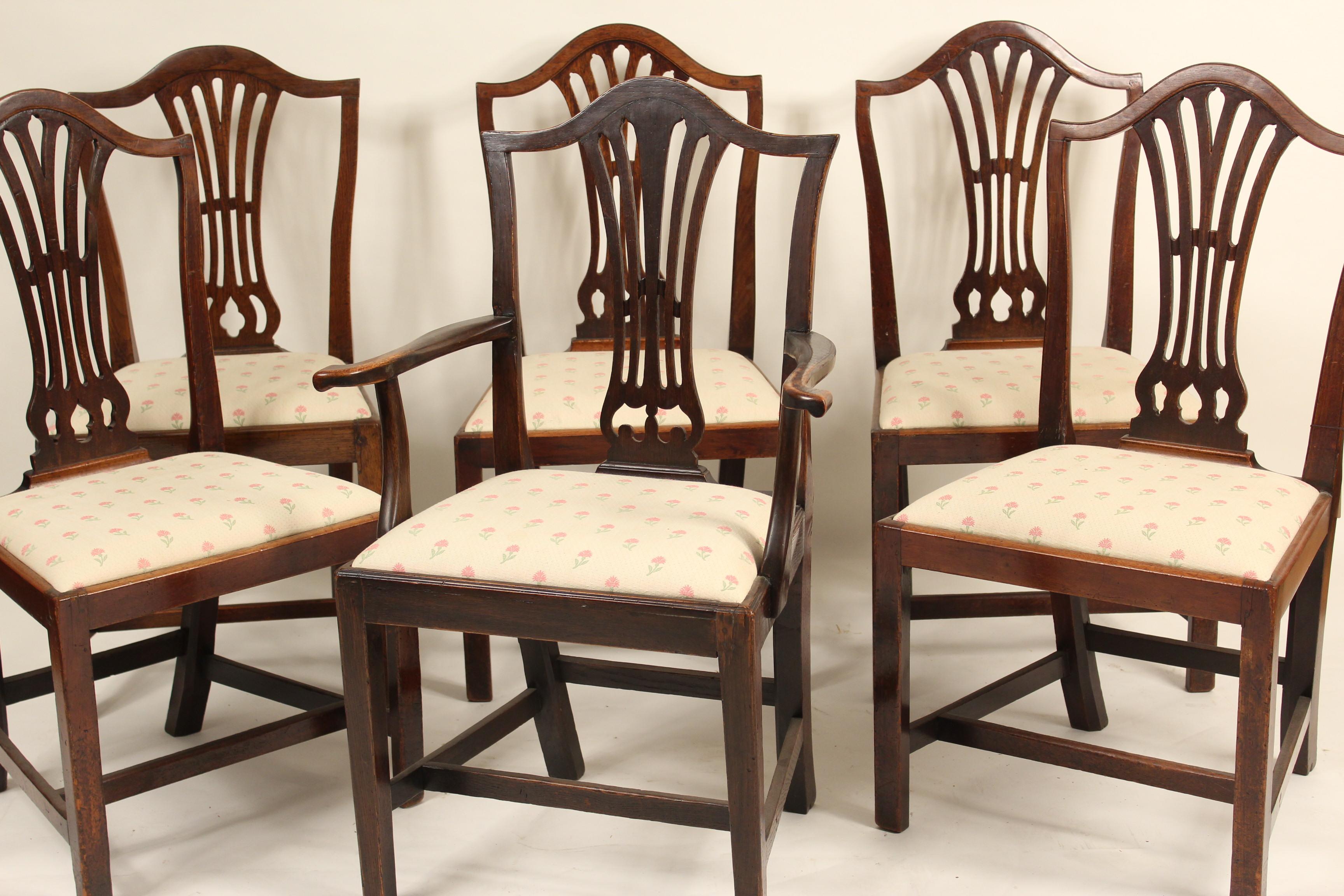 Matched set of 6 antique George III style dining room chairs, 5 side chairs and one armchair, early 19th century. The armchair is oak, one side chair is elm the other 4 side chairs are mahogany. All chairs have nice old color. The armchair measures,