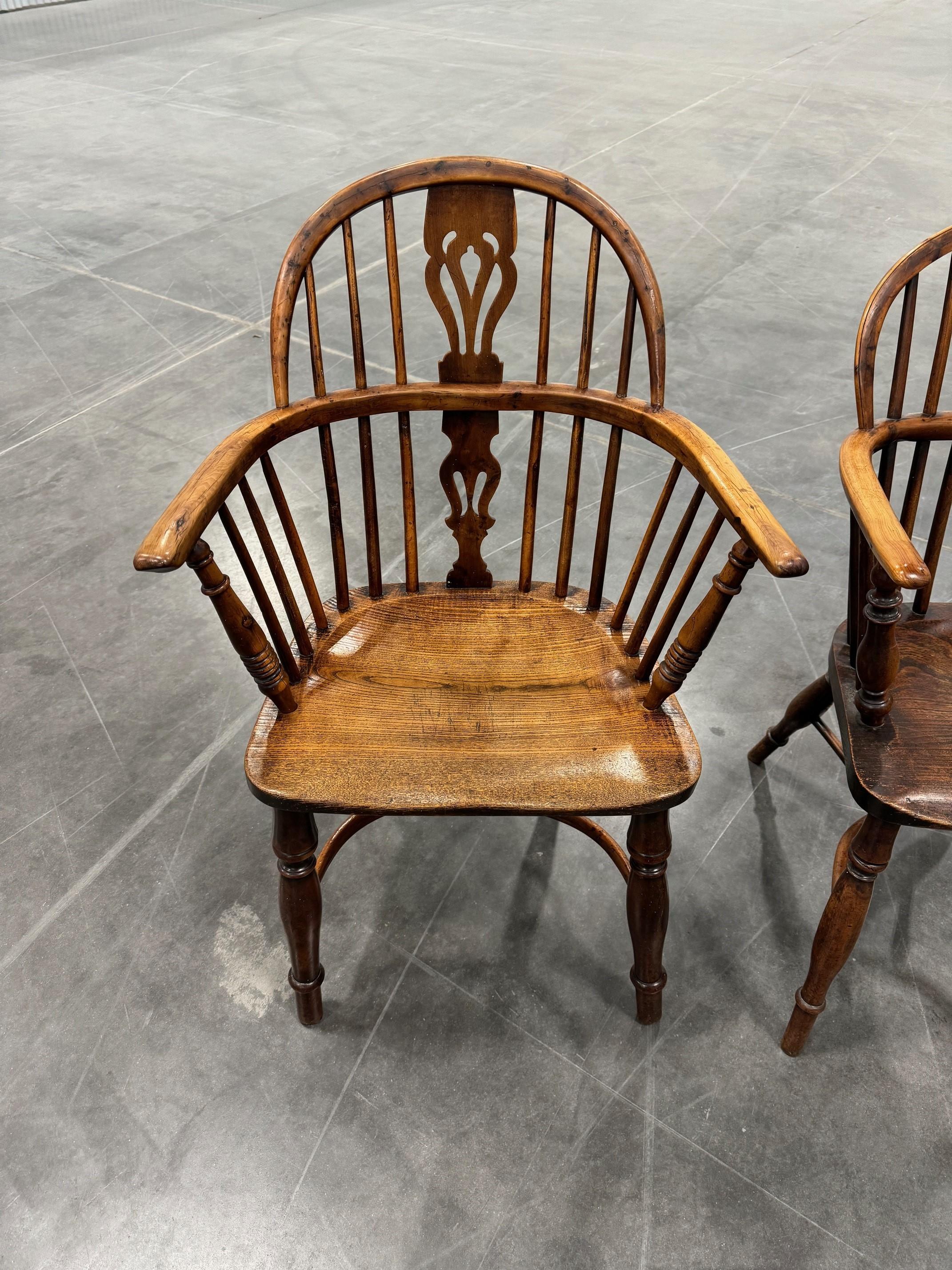 A wonderful matching pair of early Victorian Low back Yew wood and Elm  Windsor Chairs.
With turned arm supports, splat back and a carved trace outline all around the edge of the seat. The mortised back spindles are all in good shape. The baluster