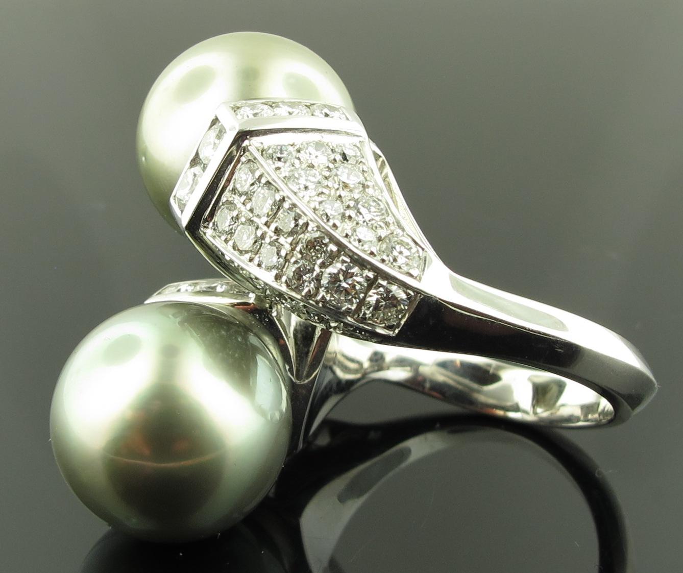 2 matching Tahitian pearls, 14 mm each, set in 18 karat white gold in a cross over setting, with 3.75 carats of round brilliant cut diamonds. F-G in color, VS in clarity.  Ring size 7.5.