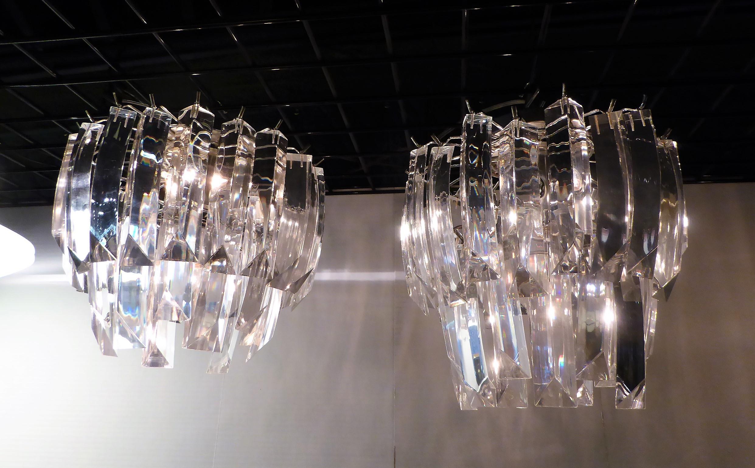Sold individually, a matching pair of midcentury two-tier flush mount lights with Lucite crystals. Just slightly different in size, one is 1/2 inch longer from the ceiling. Both have the same amount of Lucite Crystals and have the same 12 inch