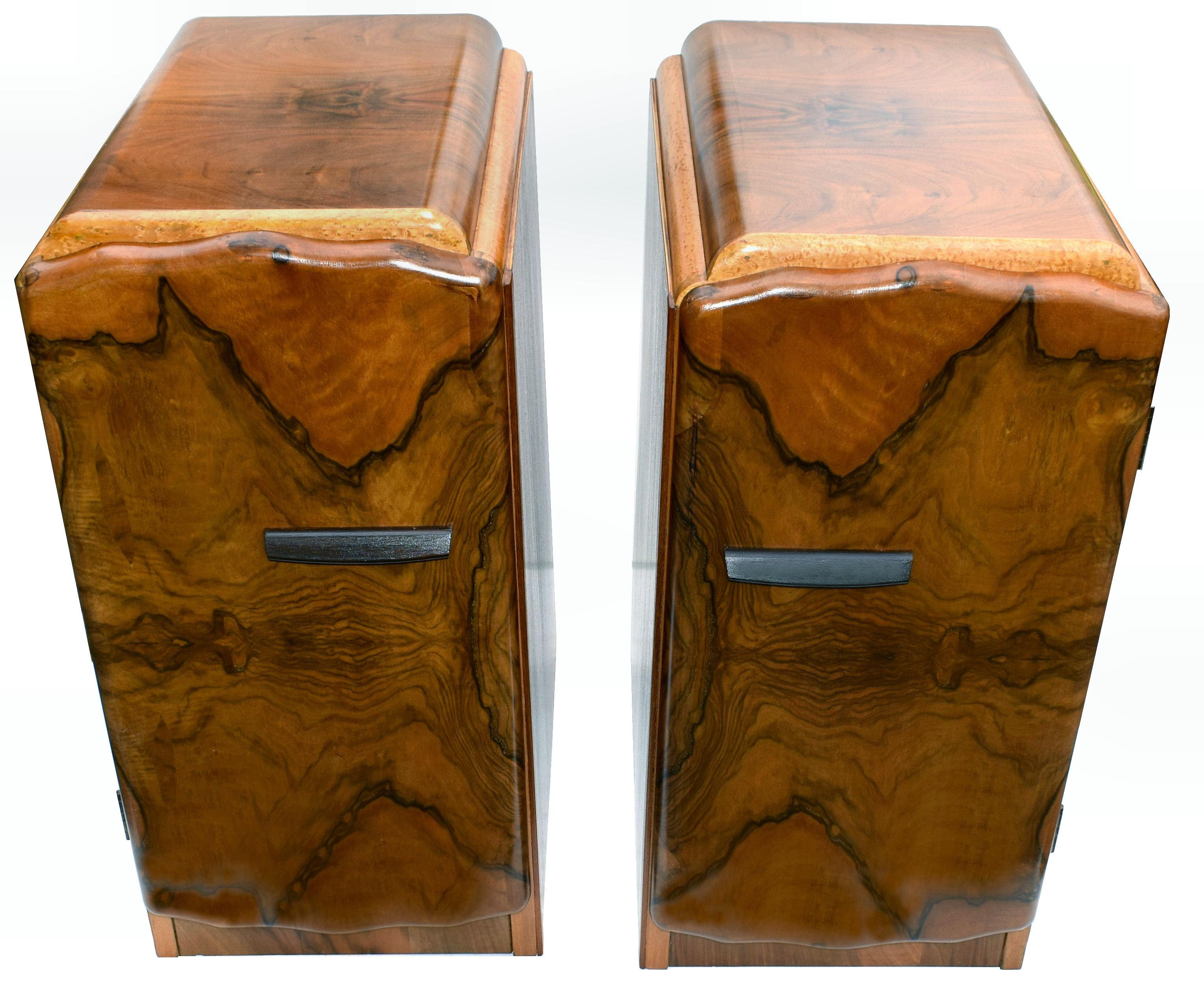 Fabulous pair of matching 1930s Art Deco bedside tables in heavily figured walnut veneer with contrasting blonde birds eye maple. Two generously sized internal storage areas by way of three open shelves. We've had both cabinets fully and