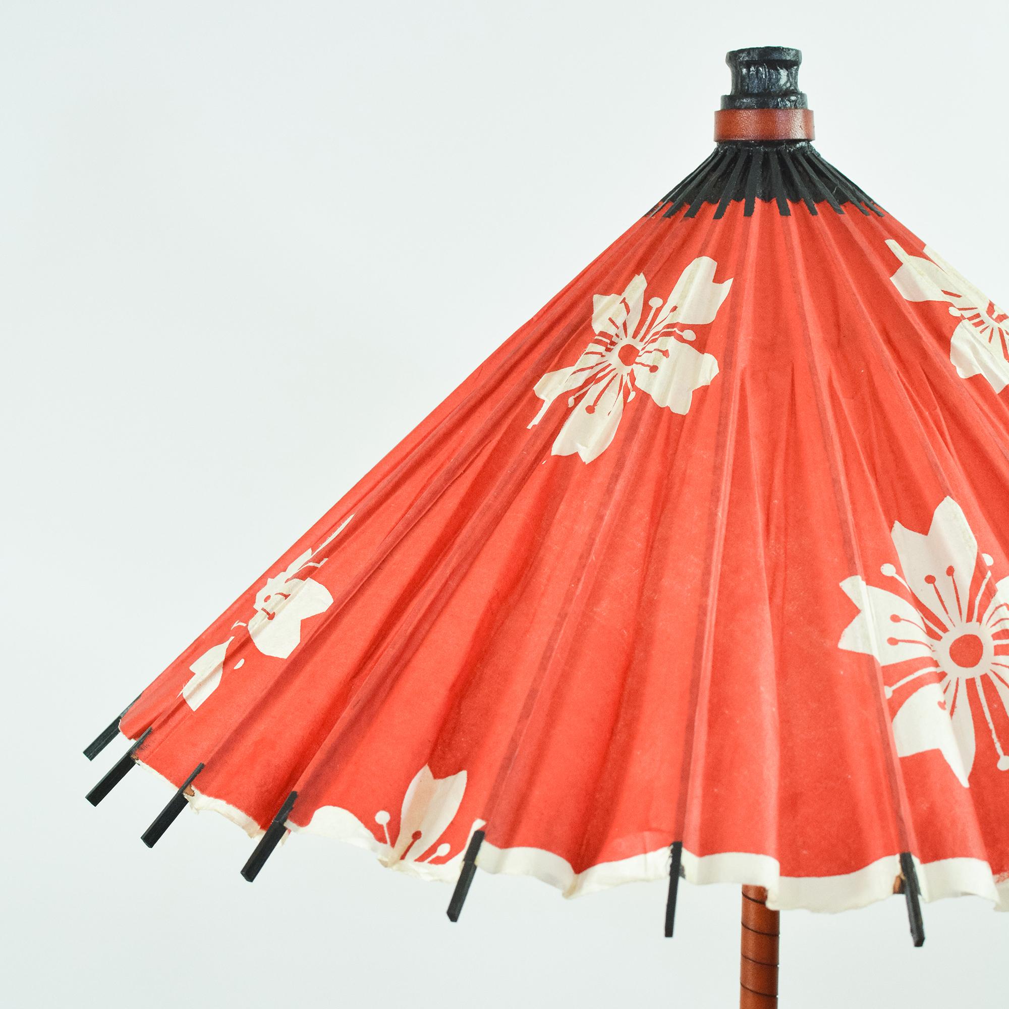 The One of One Collection is an ongoing series of limited-edition lamps featuring shades made from particularly rare vintage paper parasols from our archive. 

Model No. 037 is a limited-edition table lamp topped with an upcycled red rice-paper