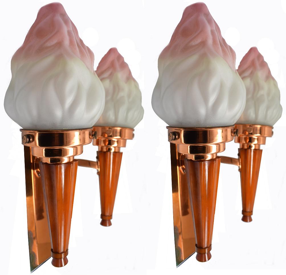 A very rare chance to acquire a pair of double matching Art Deco wall light sconces. Made from butterscotch colored catalin/phenolic Bakelite and copper metal-ware, all with original frosted glass flame shades with soft pink ends. These lights make