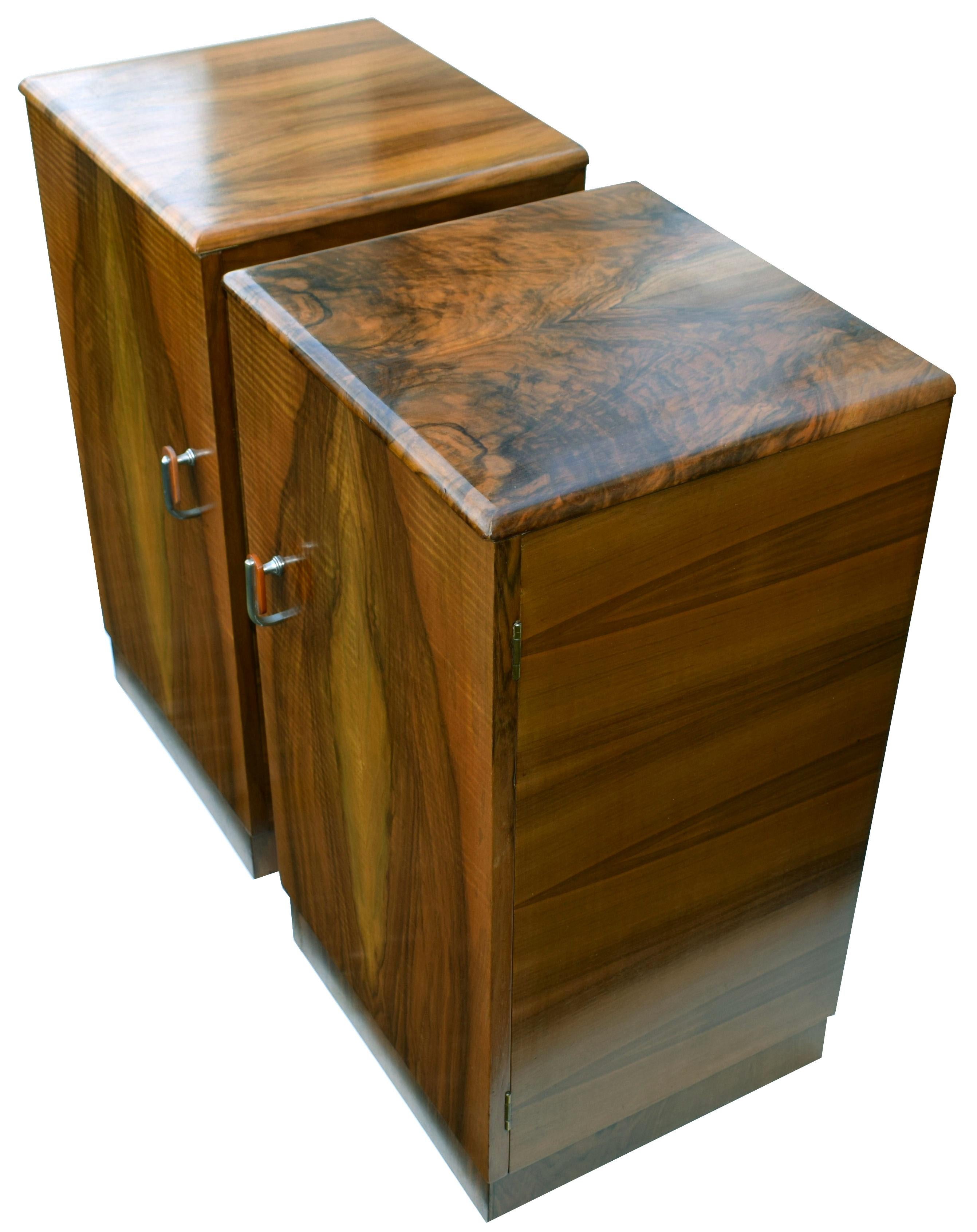Fabulous pair of matching 1930s Art Deco bedside tables in attractively figured walnut veneer. Two generously sized internal storage areas. We've had both cabinets fully and professionally restored and so come to you in excellent condition. Both