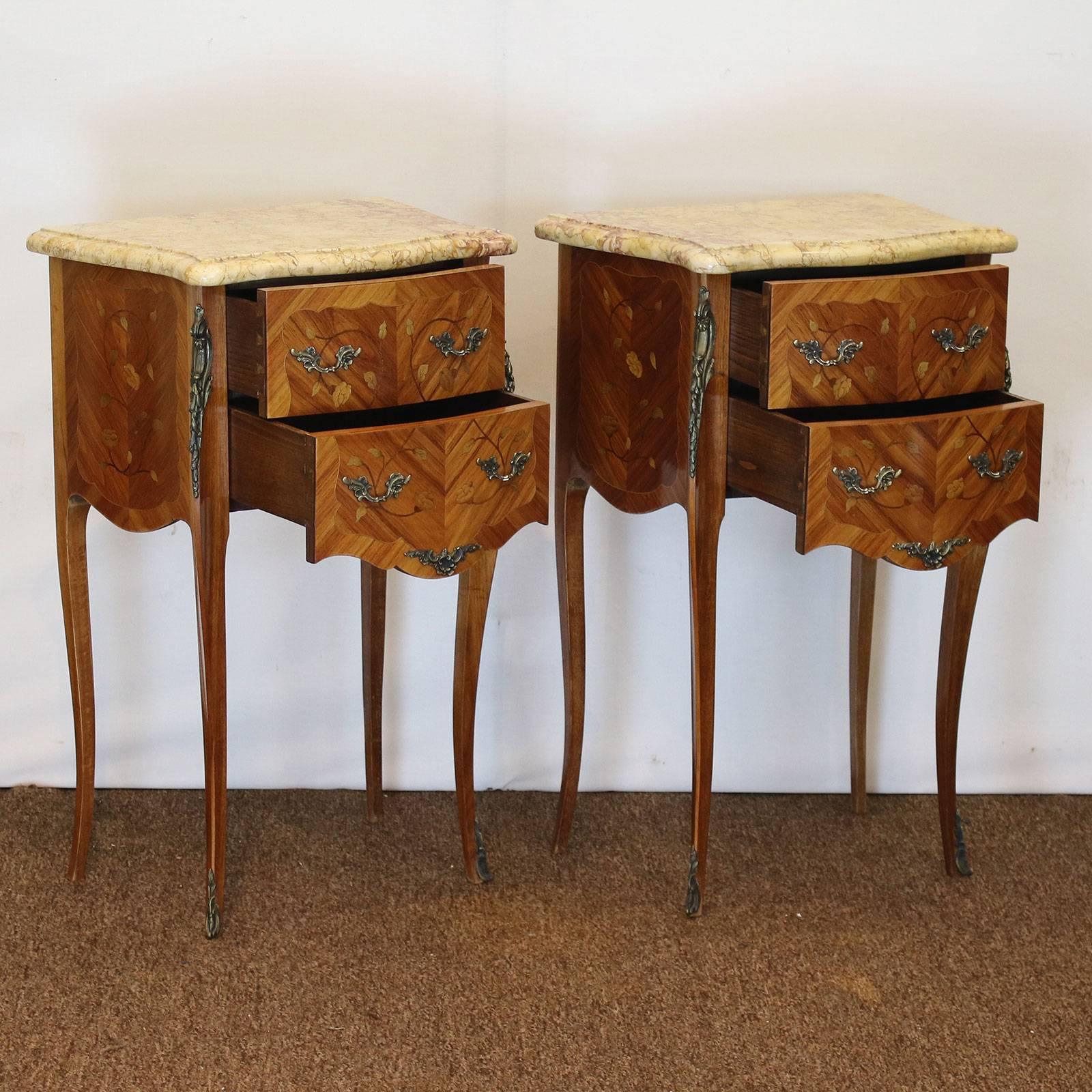An elegant pair of matching bedside tables with marble tops. These bedside tables have two working drawers and are finished with decorative fruitwood inlay work. These bedside table are part of a set with code D1 and code D2.