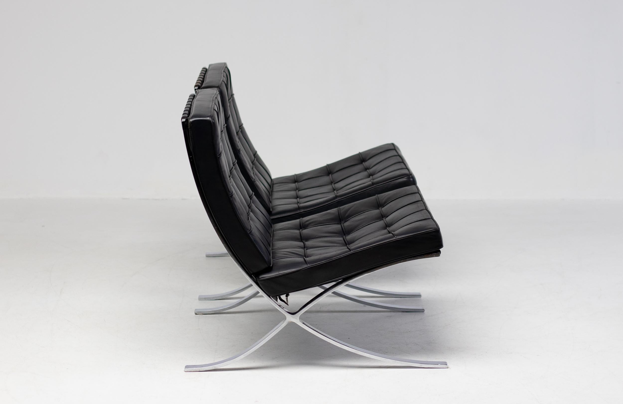 Pair of Barcelona chairs by Mies Van der Rohe for Knoll International in black leather.
Engraved with signature in the frame and marked with Knoll logo at the bottom of the cushions.
Wonderful vintage condition.
Priced as a pair.

One of the most