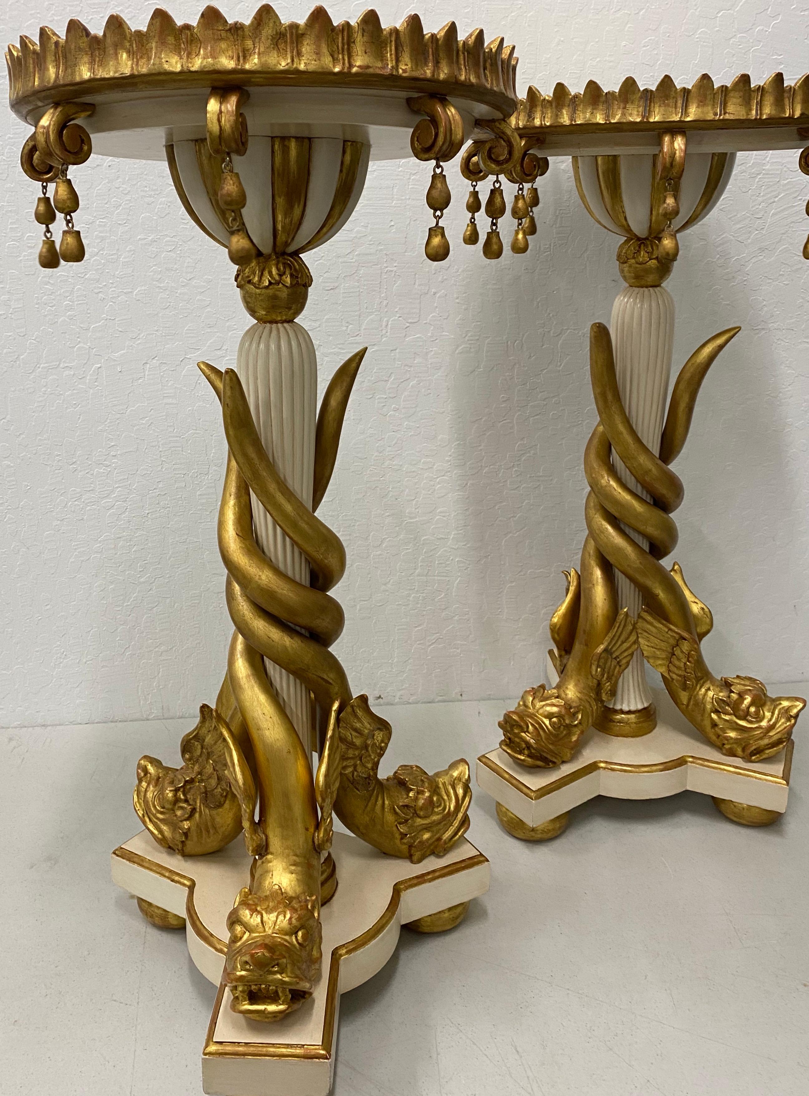 Matching pair of carved and gilded marble-top gueridon stands, circa 1940

Three carved and gilded mythological water serpents supporting a central stand with a marble top. These will make great plant stands, side tables, etc.

Triangular base