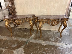 Matching pair, of French Louis XV gilt wood marble top console tables