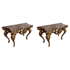 Matching pair, of French Louis XV gilt wood marble top console tables