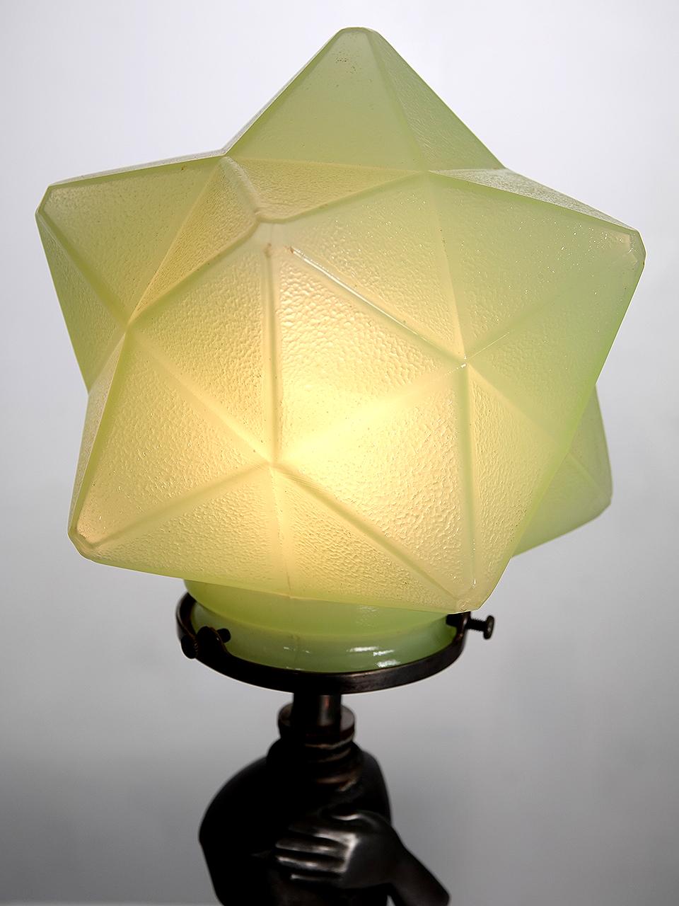 Its rare that you find a matching pair of Deco lamps. These have a Hollywood Deco feel that is quite unique. The shades area multi-sided starburst in a mint green art glass. It may also be Uranium Glass... but not sure. The base is a dark cast metal