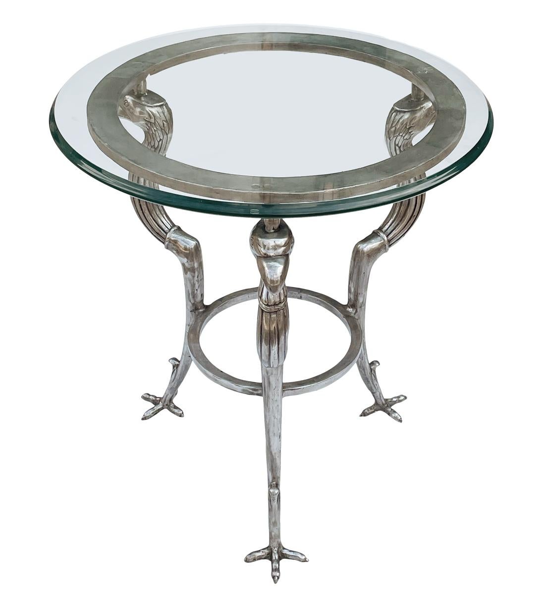 Gorgeous and Sophisticated bird form side tables by Maitland Smith circa 1970's These feature solid pewter / steel metal bases with thick glass tops. Manufacturer labels.