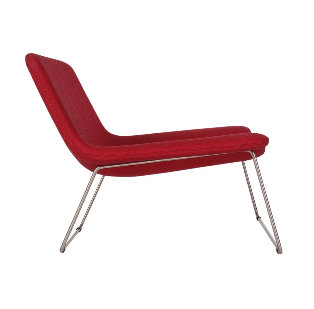 An ultra sleek matching pair of slipper chairs made by Cappellini in Italy. They feature minimal steel frames and red fabric cushions. Very comfortable chairs. Price includes the pair. Manufacturers label.