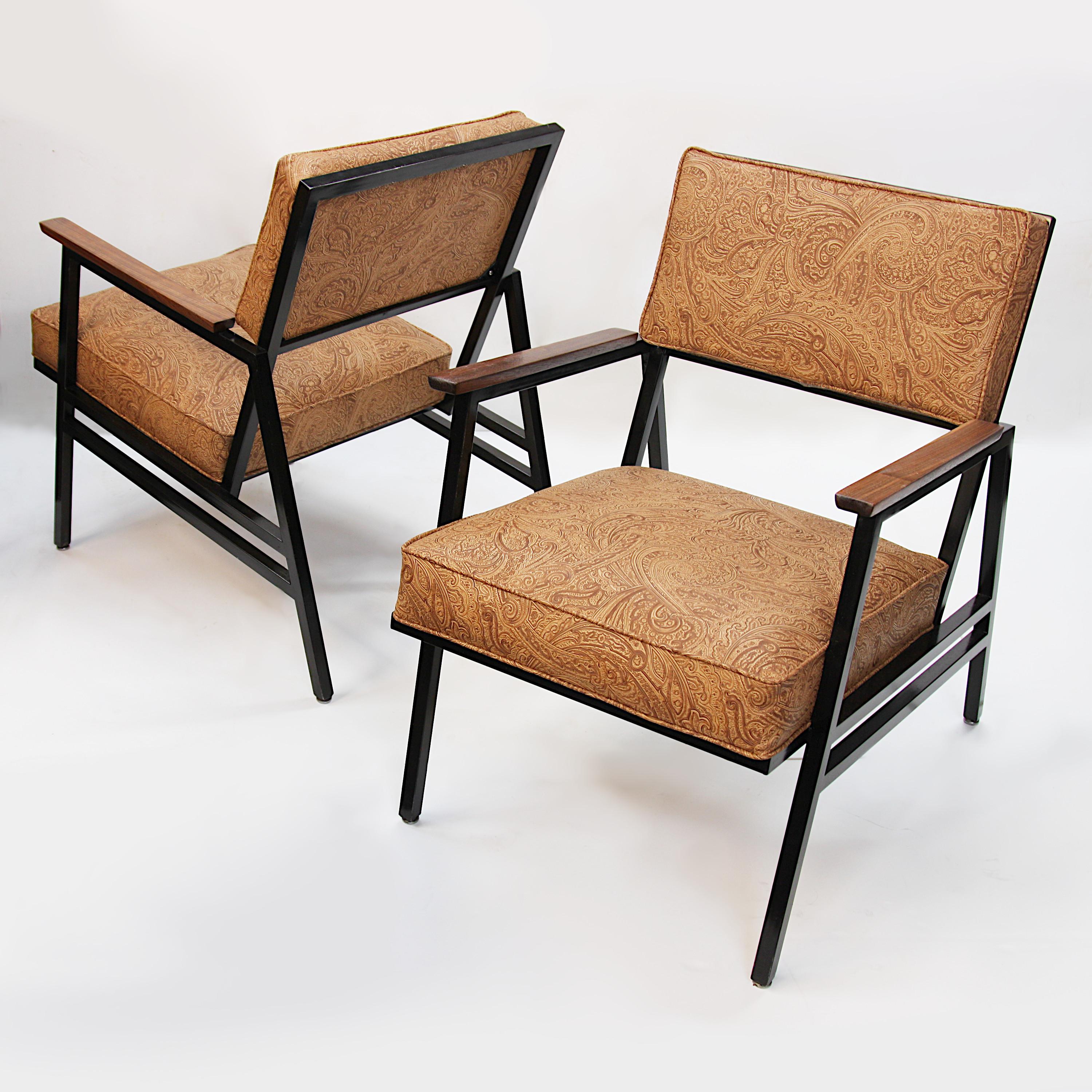 Charming pair of streel-frame arm chairs built in 1965 by Steelcase Inc. Chairs feature angular, black-painted steel frames, walnut armrests and new saddle-brown vinyl embossed with a classic, western-inspired, paisley motif. With their