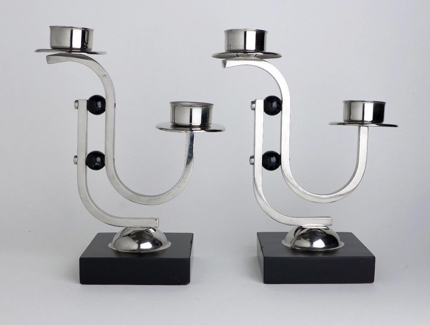 Highly styled Modernist Art Deco matching pair of candelabra in lacquered ebonized wood and chromed metal. Dating to the 1930s and originating from Belgium. The condition of the chromium is very good as is the black wood.
     