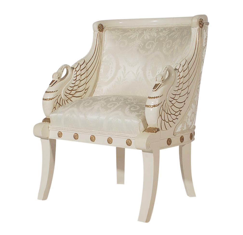 A stunning Italian pair of carved swan arm chairs. These feature solid wood frames, bone white lacquer with gold accents, and printed upholstery. Original condition and ready to use.