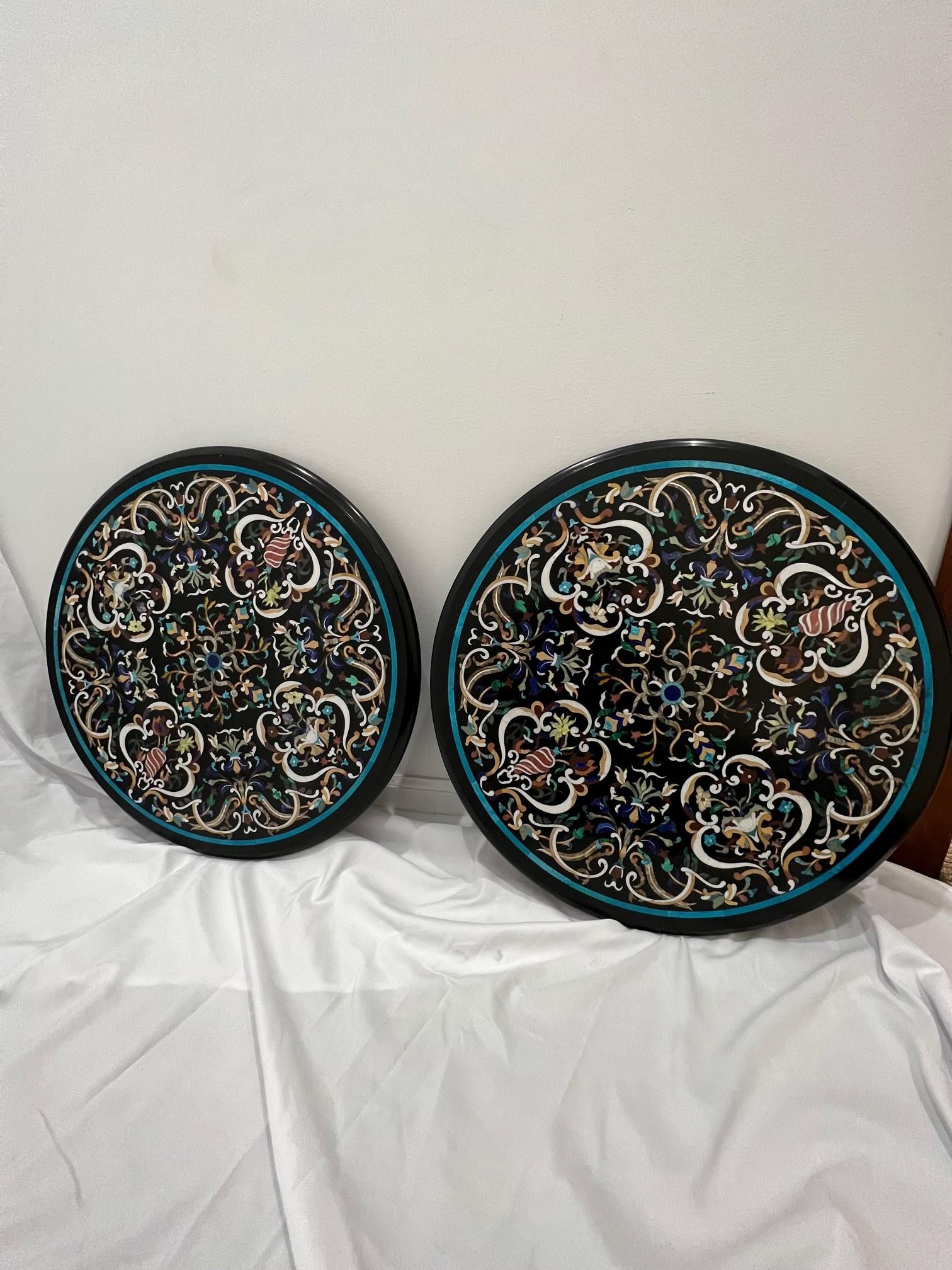 Beautiful matching pair of Pietra Dura round table tops loaded with semi-precious stones including lapis and turquoise. Each top is handmade and it is unusual to have a matching pair they are amazing.
