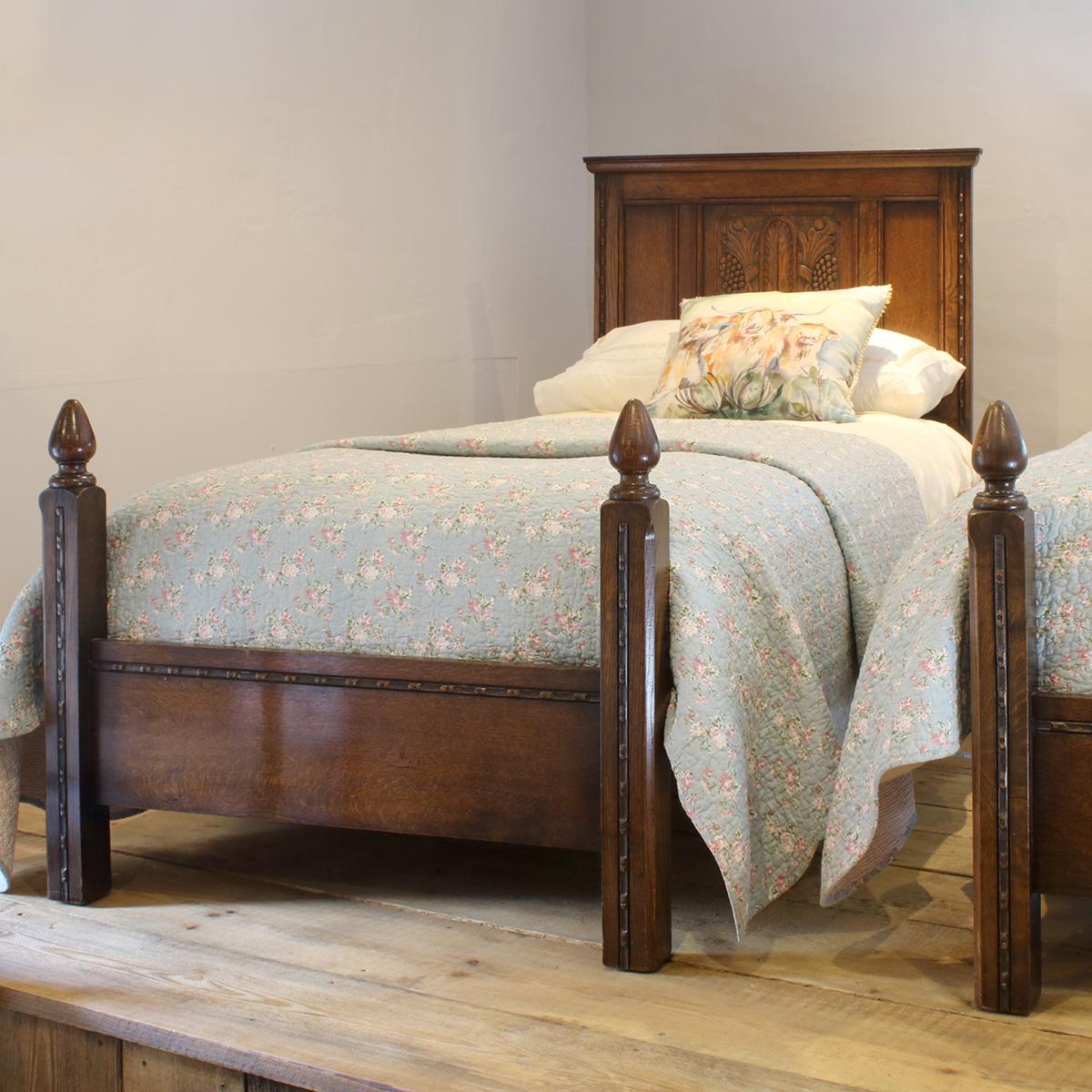 Matching pair of oak early 20th century beds with carved paneled backboards and torchon feet.

These beds accept 3ft wide (36 inches) bases and mattresses.
They can be any length required (75 inches, 78 inches or more) and can stand together to