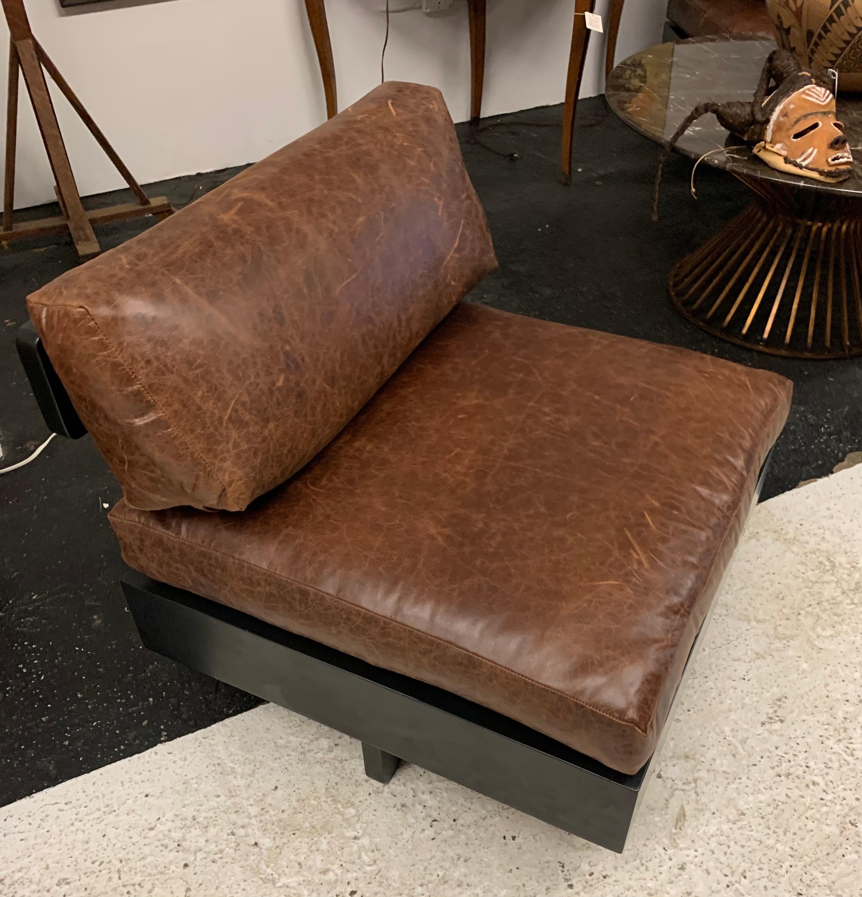 Rare set of T back black framed chair offset with brown leather. Iconic mid century lines and great scale. Now, more than ever, home is where the heart is.