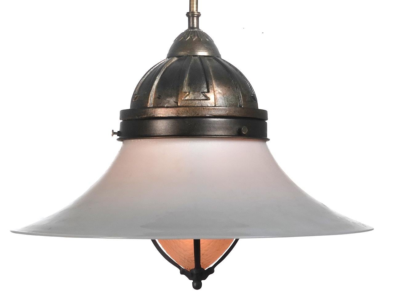 This is a very interesting and matching pair of lamps. They are priced and sold as a pair. The 15 inch diameter smooth outer shade is milk glass and has a graceful swiping profile. The inner elongated acorn shade has a frosted glass finish with a