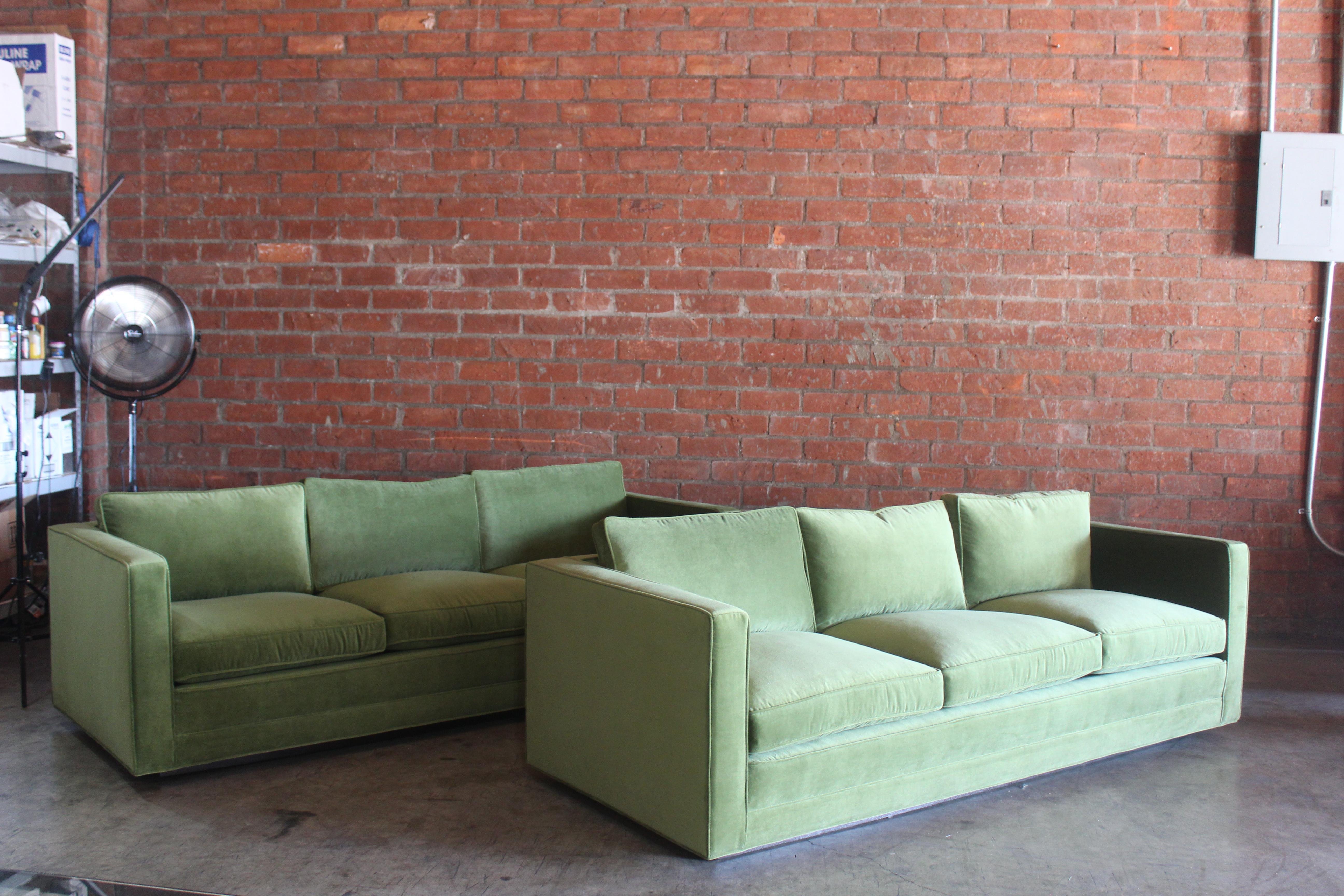 Pair of matching tuxedo sofas designed by Edward Wormley for Dunbar, U.S.A, 1950s. Each sofa has been restored with new avocado green cotton velvet. The original Dunbar fabric has been saved and appears under the seat cushions. These sofas sit on