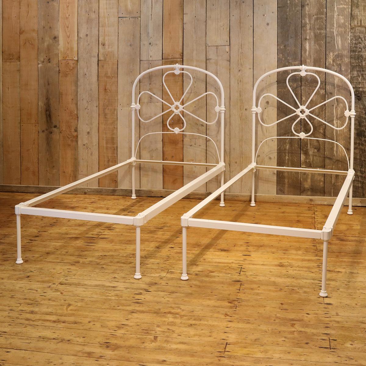A matching pair of twin iron beds finished in white with hoop design and decorative castings.

These beds accept 3ft wide (36 inch or 90 cm) bases and mattresses.

The length can be 75 inches, 78 inches or more if required.

These beds can be