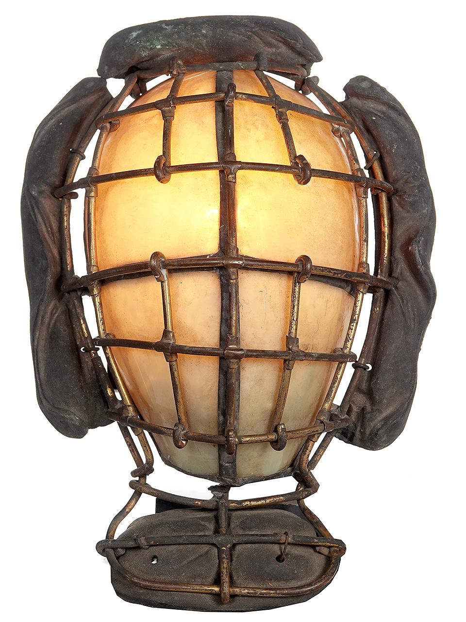 You won't see another pair of these lamps. They were artist/craftsmen made back in the 1930s. Definitely unique and a bit bazaar. The matching pair started life early baseball catchers masks. The glass behind the mask is made from 4 pieces of leaded