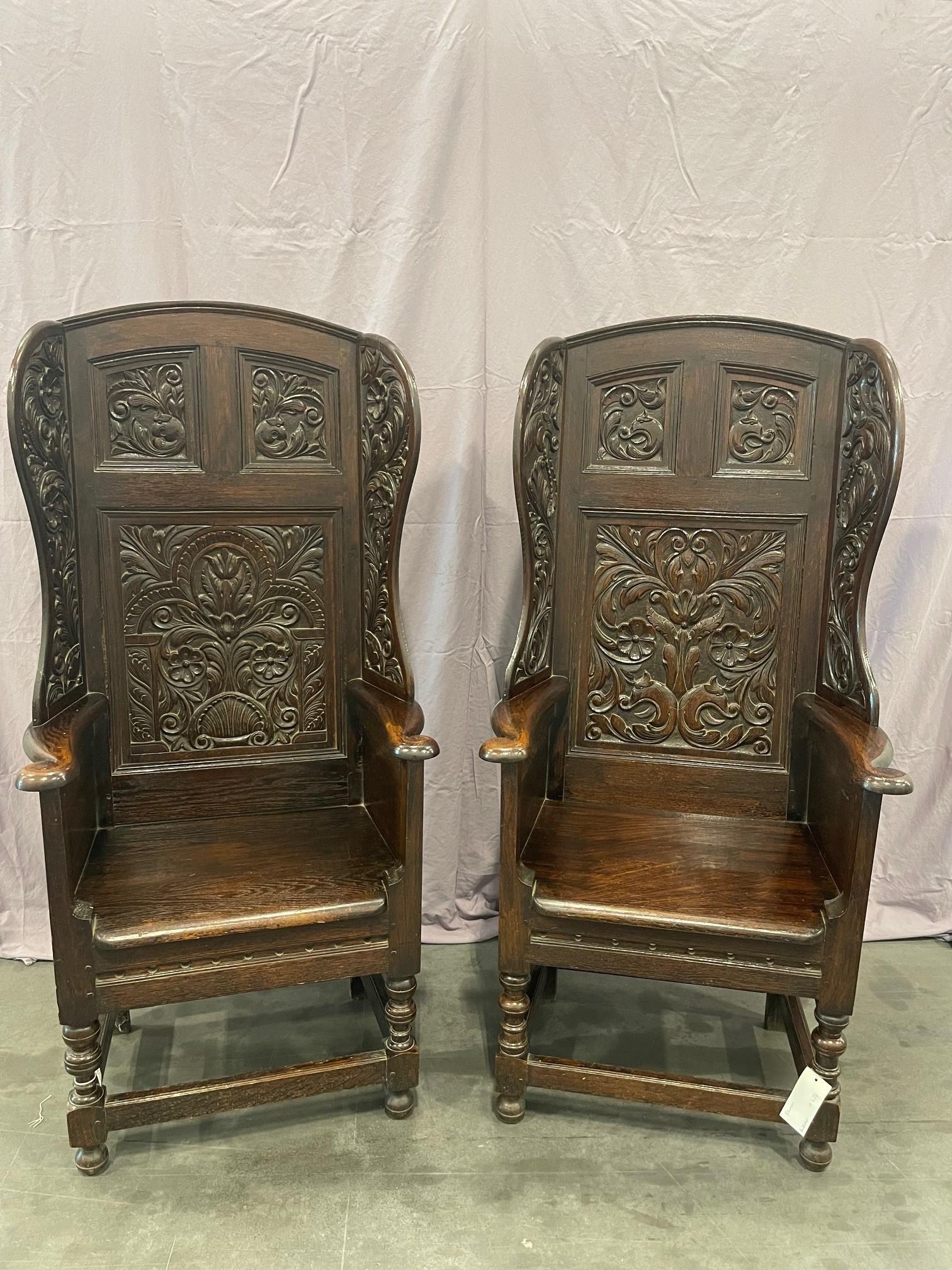 A lovely pair of heavily carved Victorian oak wing back armchairs. These chairs have intricate carvings on the back panels, side wings and exterior sides panels all done in the style of the 17th. Circa 1850

Provenance: These were acquired from “The