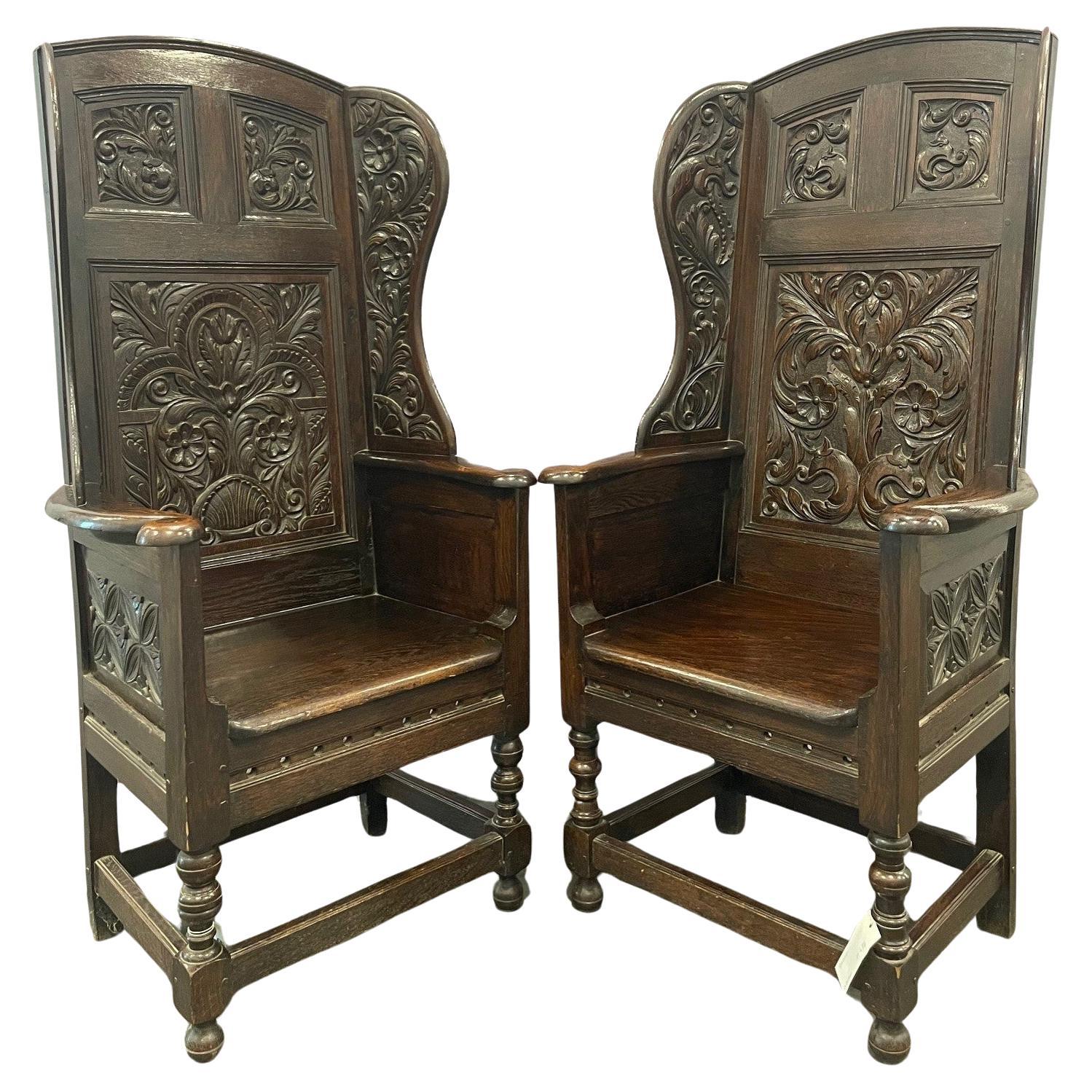 Matching pair of Victorian Carved Oak Wing Arm Chairs For Sale