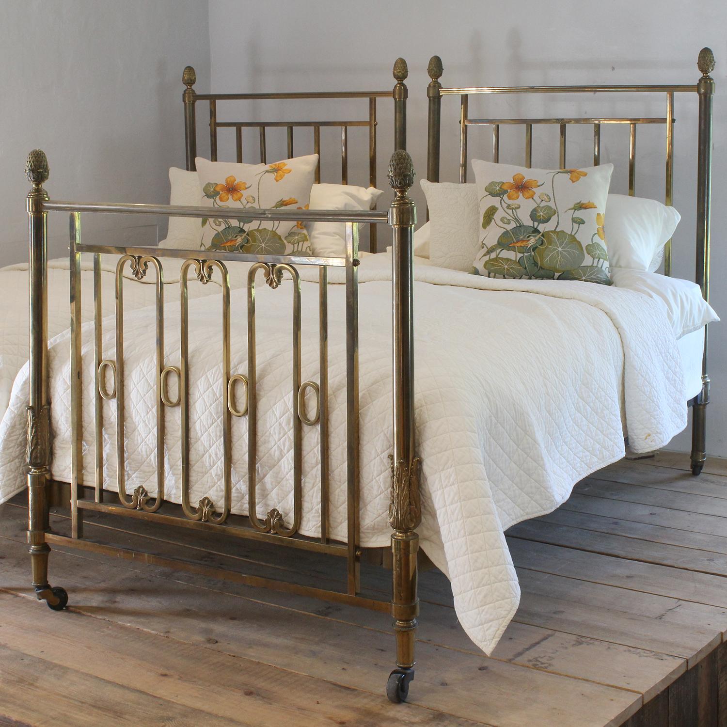 A magnificent matching pair of all brass Edwardian beds in the classical style with cast acanthus leaf detailing and pineapple style finials. The superb golden patina of the brass has been acquired over more than 100 years.

Each bed has a brass