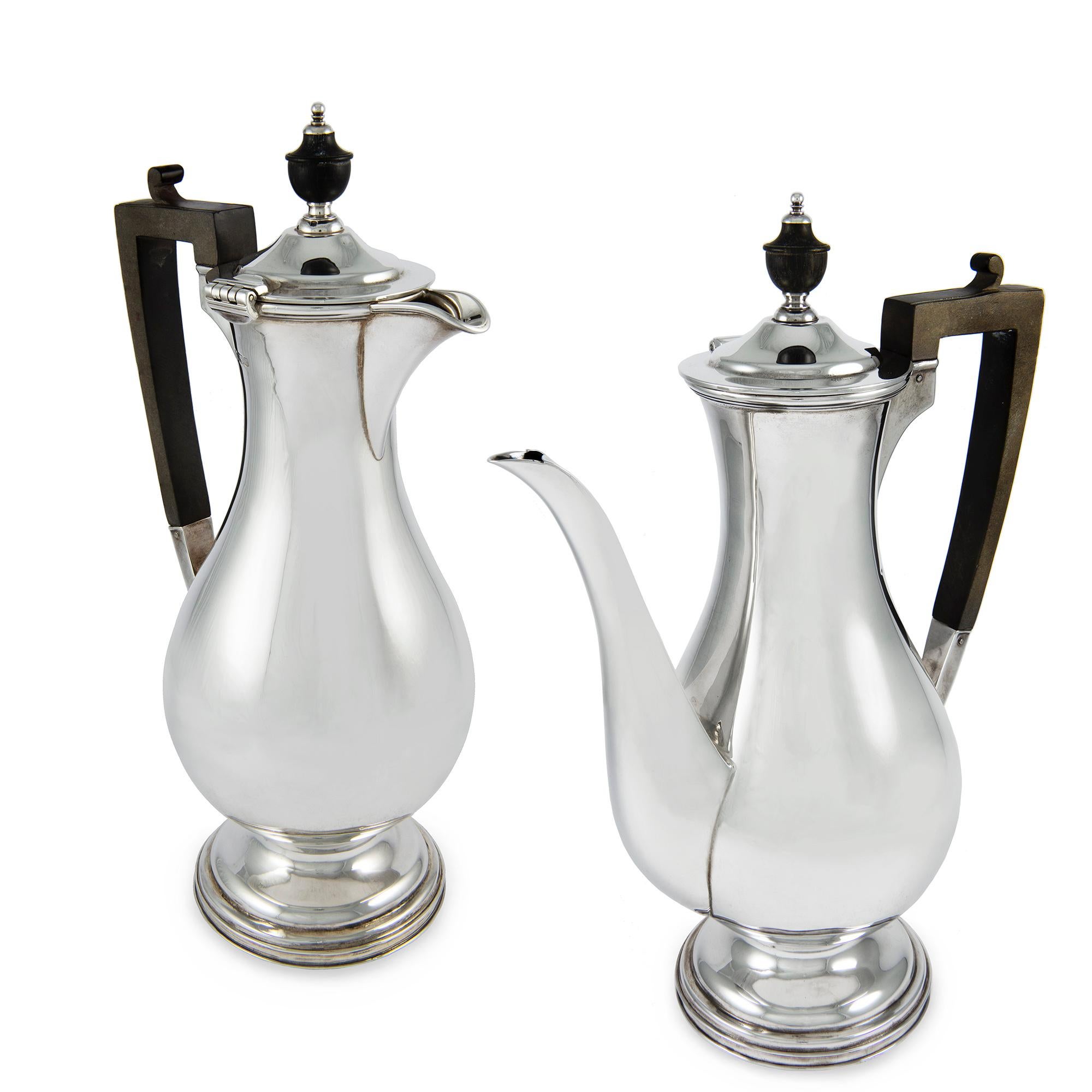 Matching sterling silver baluster shape coffee and hot water pots, with ebonised handles and finials,  hallmarked Sheffield 1923, maker G&S Co LTD, measuring approximately 28cm in height, 31ozs total weight.

Should you choose to make this purchase