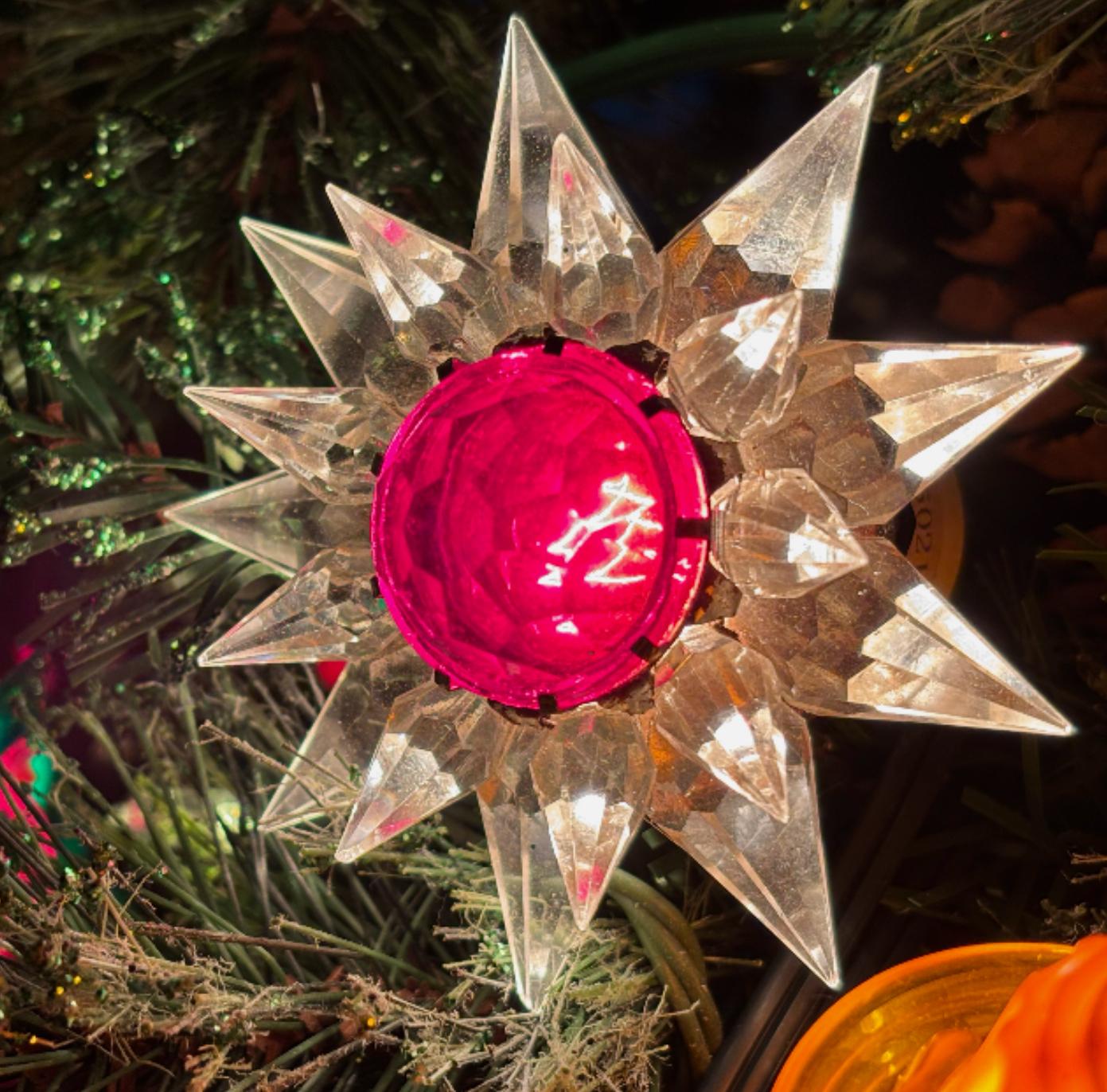 Matchless Wonder Star #910 Double Row Clear & Red Crystal C-9 Holiday Bulb, 1936. Extremely rare early crystal production in clear points with red center. 

On May 2, 1935 Paul C. Dittman of Chicago filed an application for a patent for what he