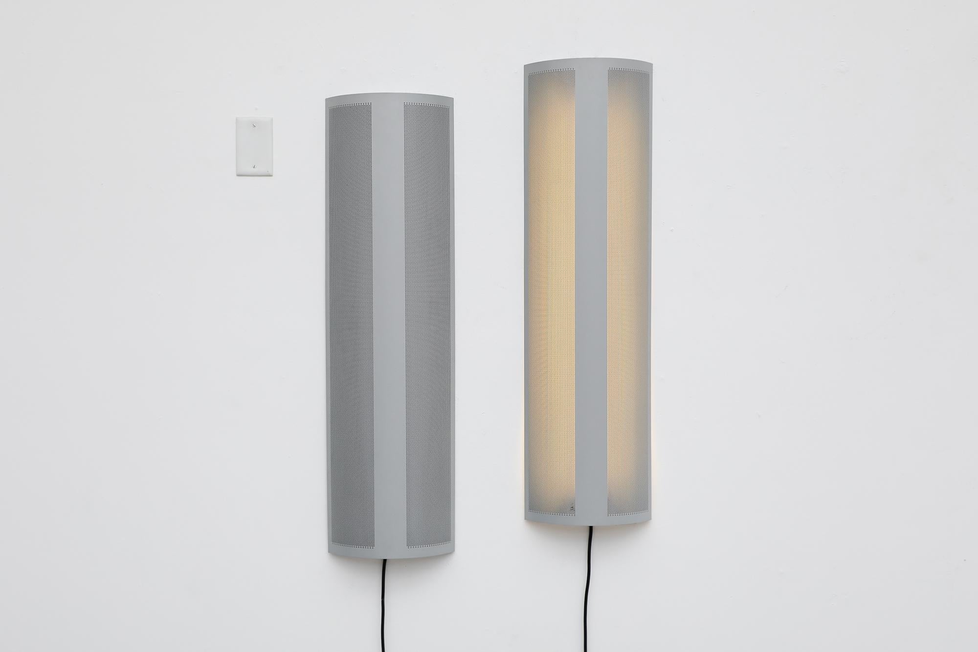 Mathieu Mategot inspired, Mod fluorescent linear wall lamps with decoratively perforated half cylinder shades. In original condition with some visible wear consistent with their age and use. Sold individually. 