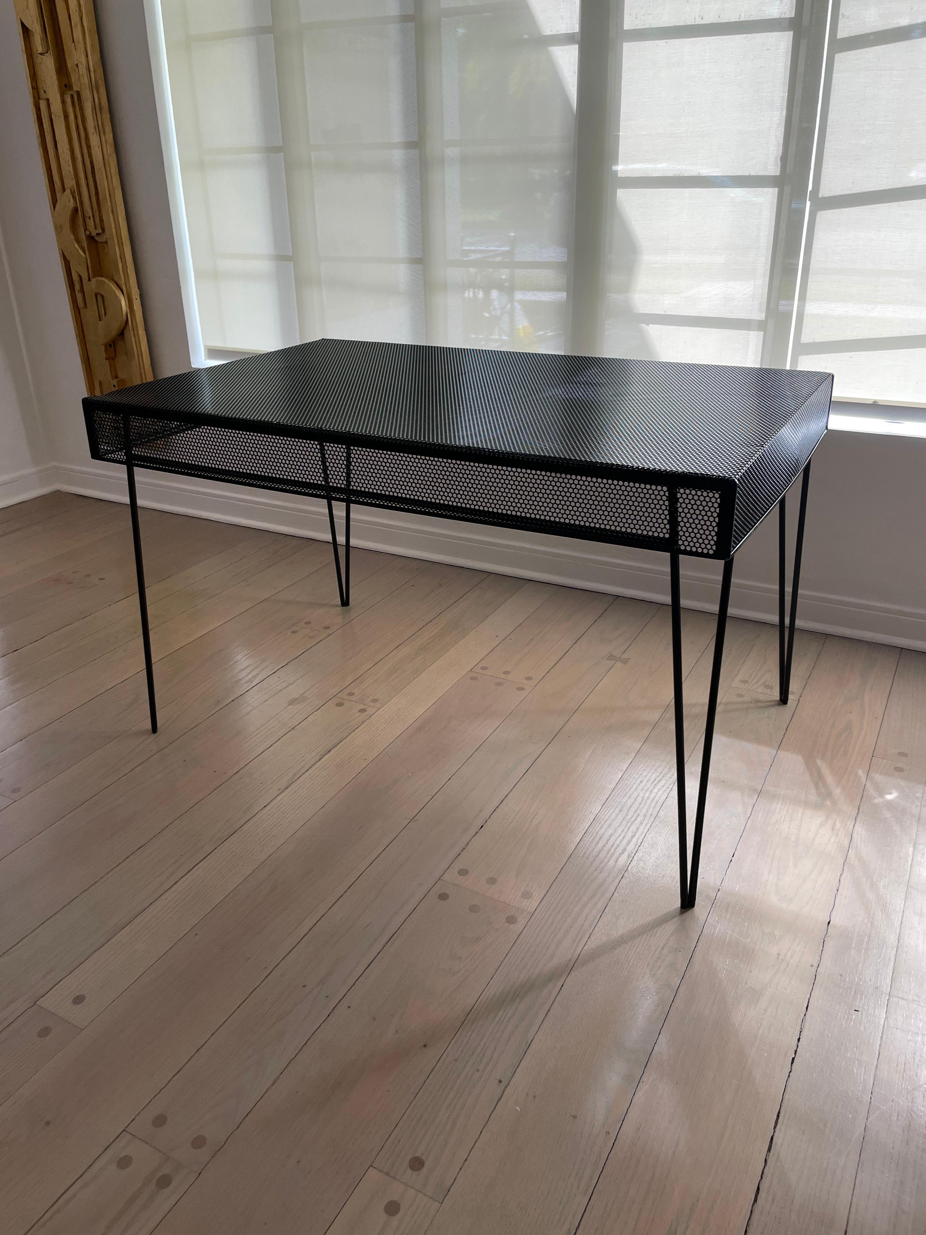 Powder-coated in black this metal table with a draped mesh top and hairpin legs. This is an awesome and chic table indoors as well as outdoors.