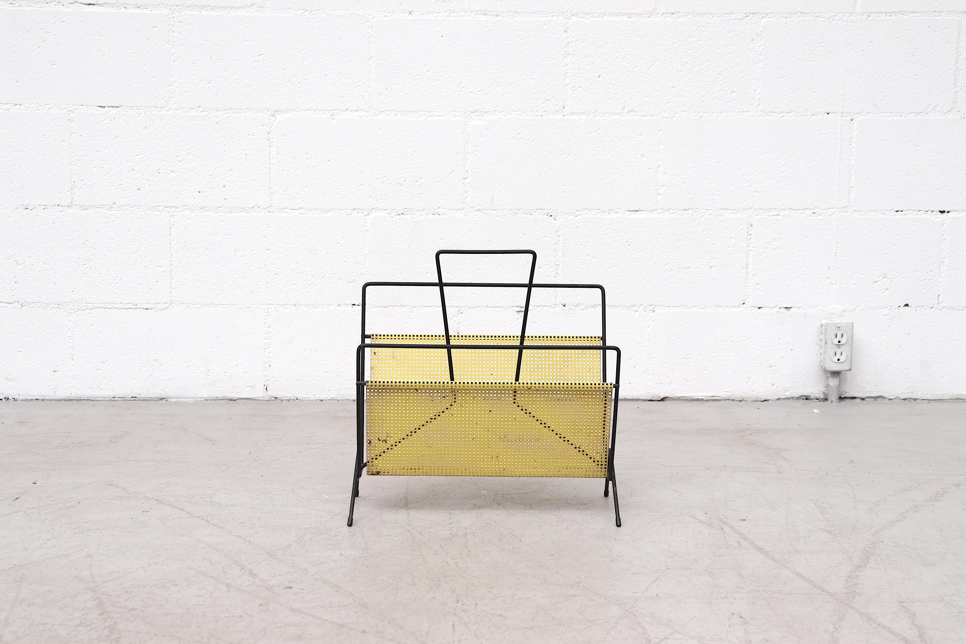 Midcentury Mategot style yellow perforated metal magazine rack with black enameled wire frame. In original condition with some visible wear and mild rust.