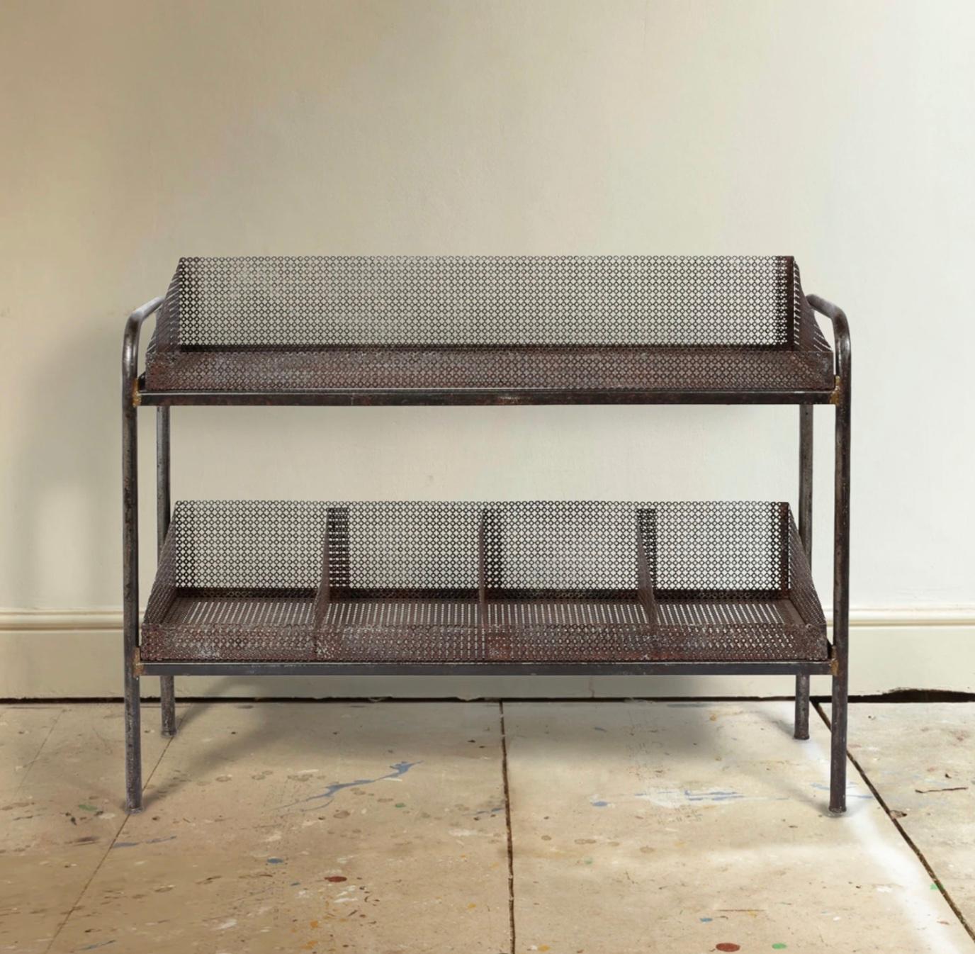 A perforated and tubular steel two-tier storage unit attributed to Mathieu Matégot. 

French c. 1950s. 

Measures: W99.5 x D35 x H73.5 cm.
 