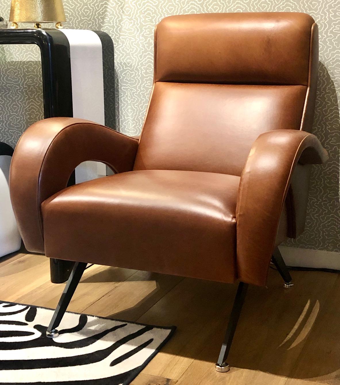 New edition to MLB Furniture collection. Midcentury style armchair in a sexy sleek design upholstered in a conjac color leather that get even better looking with age. Black steel legs with a chrome foot. 2 in stock at this time.
Can also be made in