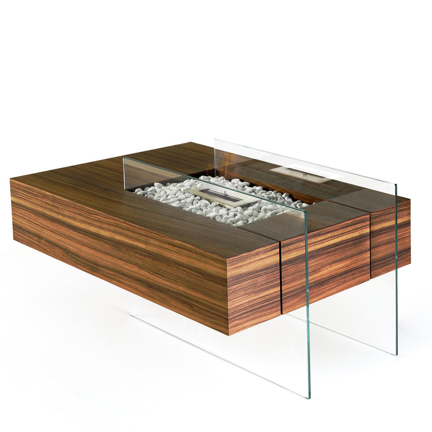 This extremely unique coffee table contains a bio-ethanol burner. Its design combines the essential elements of fire, stone, glass and Indian rosewood. The final result embodies the contrast between mass and lightness. The thick, solid top seems to