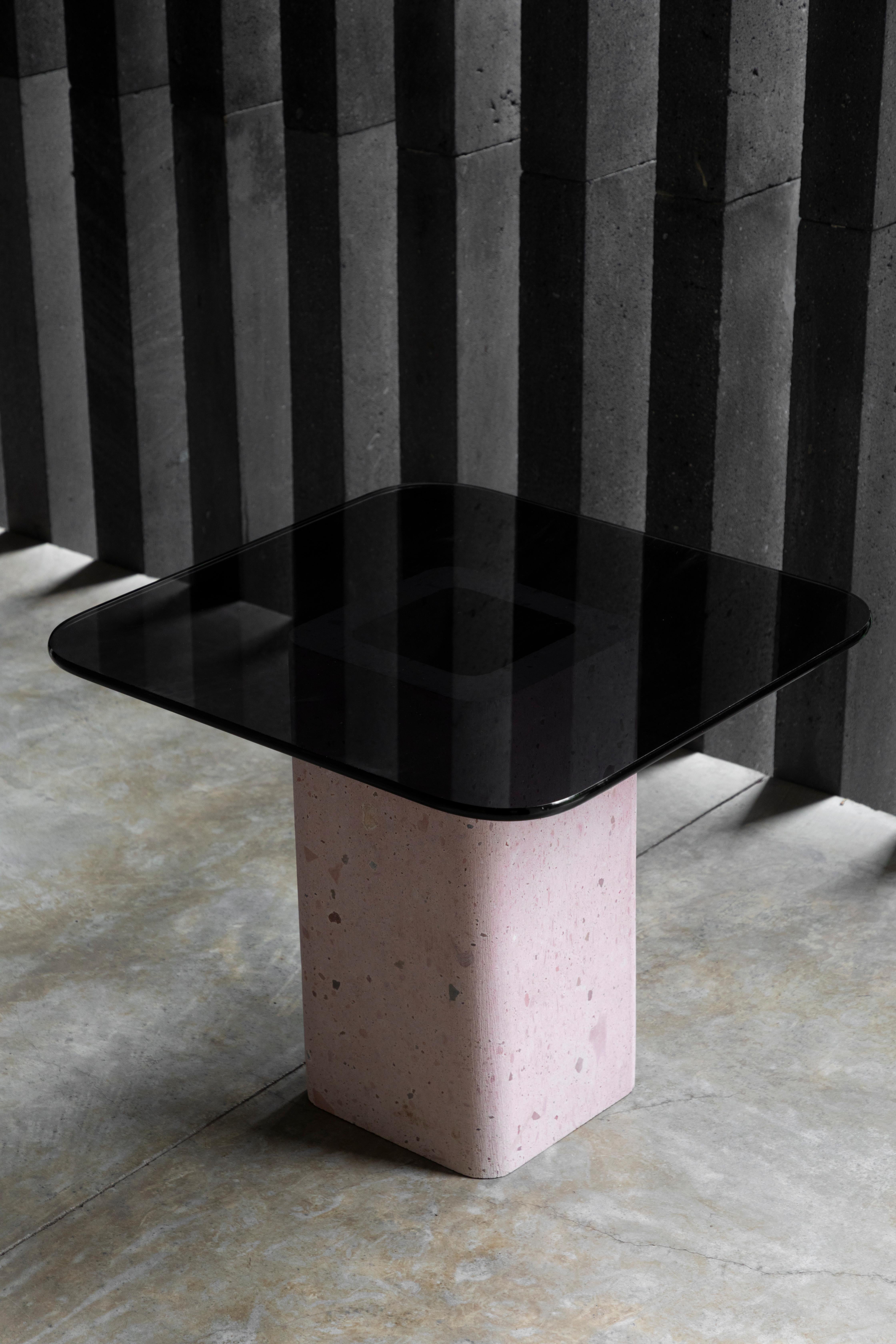 Materia side table by Brera Studio.
Limited Edition of 20 pieces.
Dimensions: Base: D 25 x W 25 x H 45 cm. Glass base: W 50 x L 50 cm.
Materials: Pink stone base and smoke-colored glass base.

Materia Table, made of pink stone, as its name