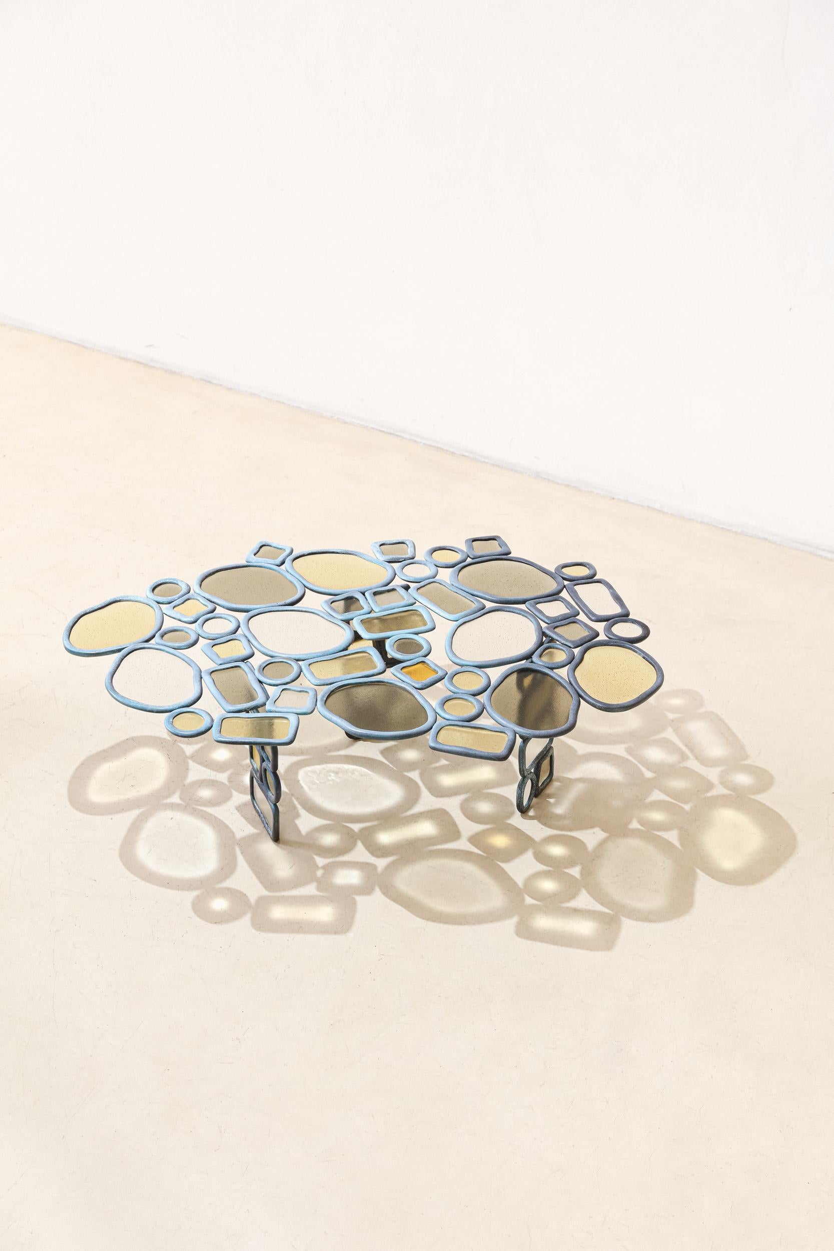 In the Material Distortion collection, Recchia combines elements in assemblages to create various pieces. Using just four ring shapes—two rounded and two rectangular—in either bronze or aluminum, different arrangements and growth directions give