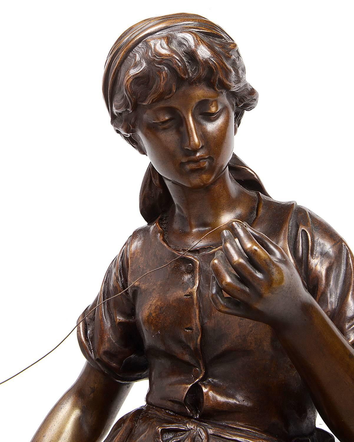 A very good quality 19th century bronze statue of a seated women spinning cotton, signed Math. Moreau (1822-1912)
