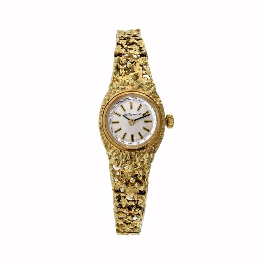 Introducing the distinguished Mathey Tissot 1960's 14kt Gold Nugget Bracelet Watch, a symbol of timeless sophistication and elegance. This exquisite timepiece features a refined 17mm round 14kt gold case complemented by a unique nugget-style