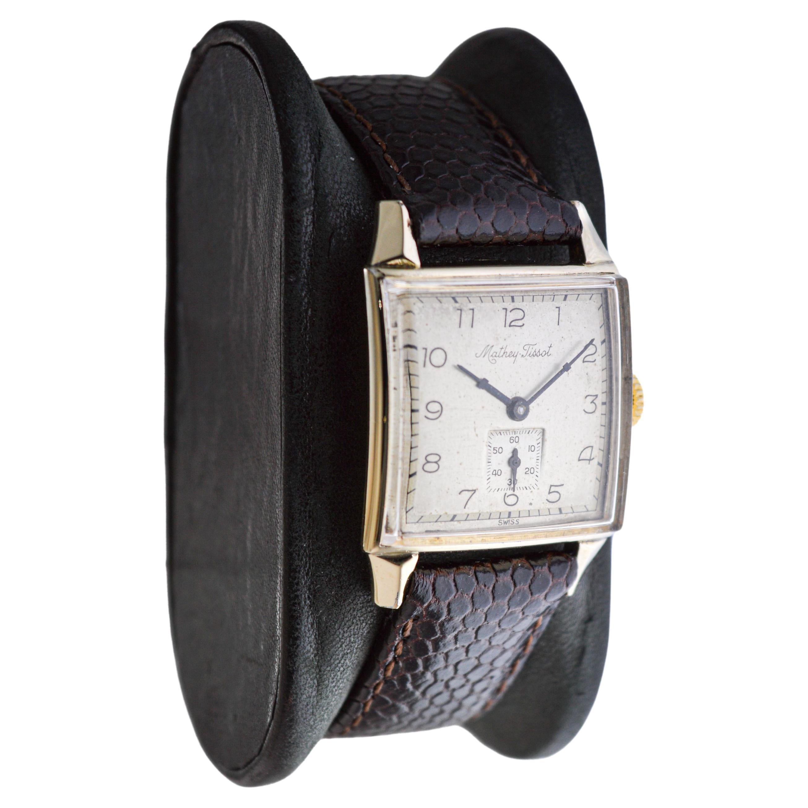 FACTORY / HOUSE: Mathey Tissot Watch Company
STYLE / REFERENCE: Art Deco Tank Style 
METAL / MATERIAL: 14k Gold Filled
CIRCA / YEAR: 1940's
DIMENSIONS / SIZE: Length 35mm x Width 25mm
MOVEMENT / CALIBER: Manual Winding / 17 Jewels / Cal.404
DIAL /