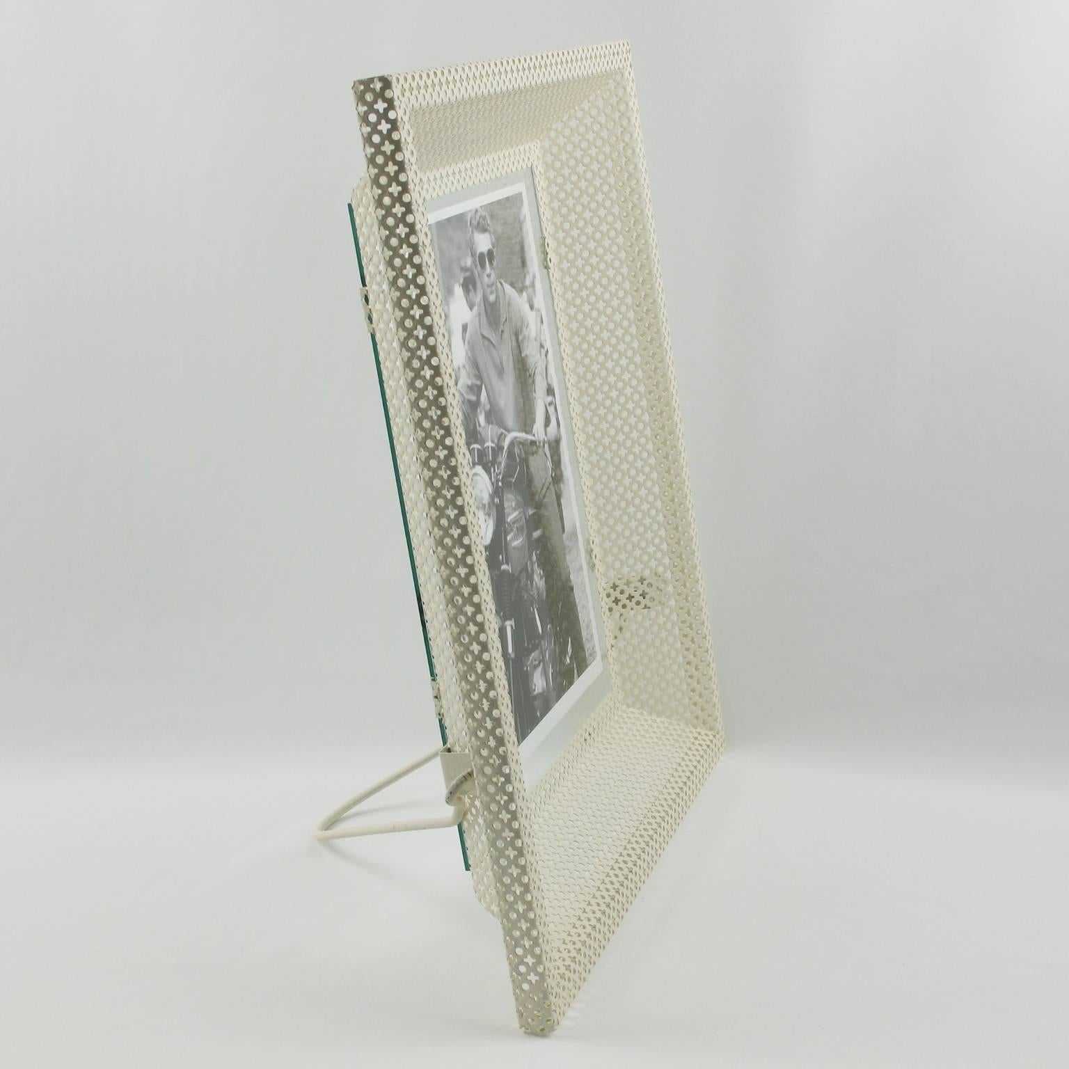 Stunning white metal picture photo frame by French designer Mathieu Mategot. A striking example of French, 1950s metalwork. Folded, perforated metal. Fine original condition. Two sheet of glass to keep the picture in position. Metal easel at the