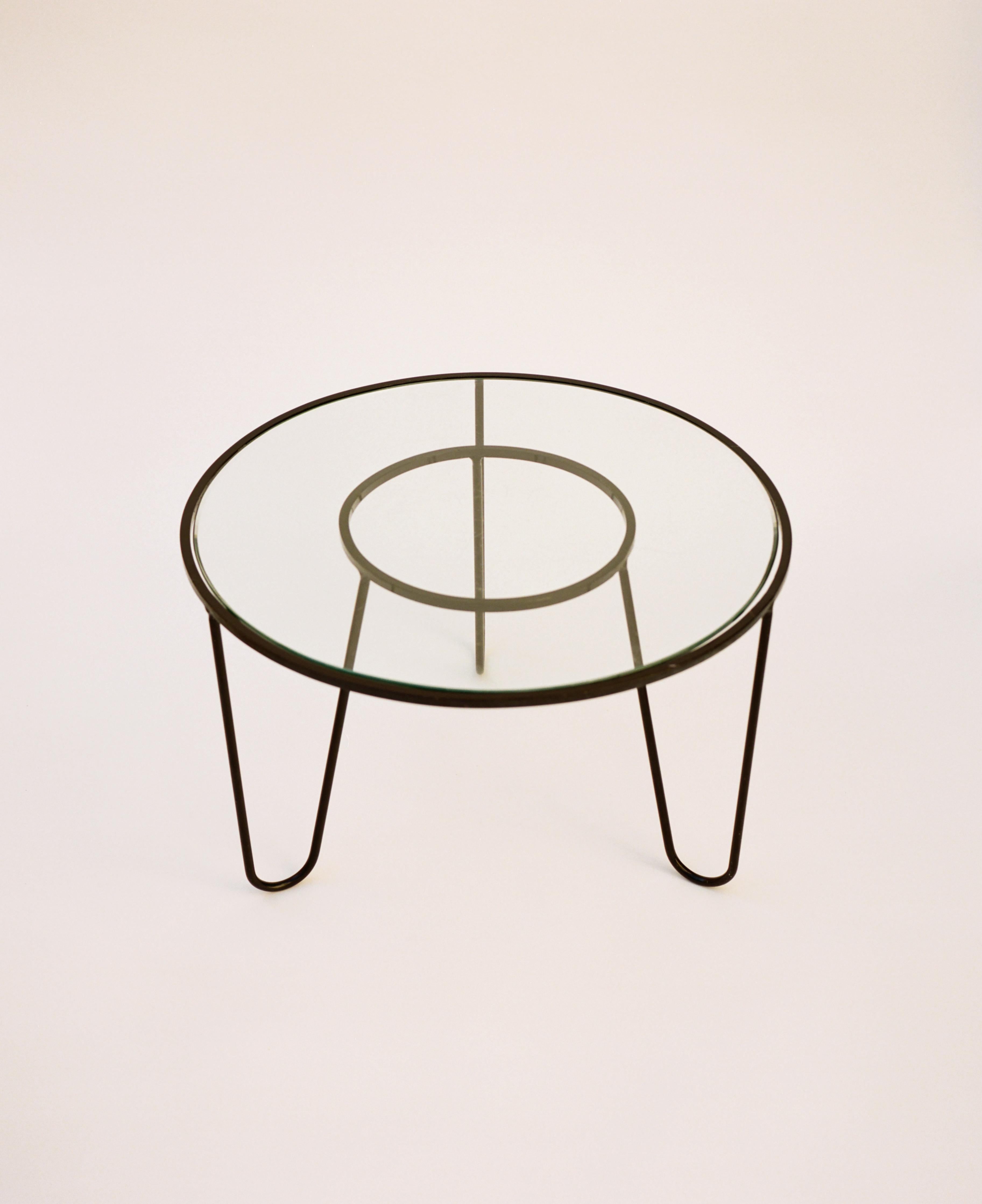 ‘Bellevue’ table designed by Mathieu Matégot in 1956. Enameled metal base and a round, beveled-edge glass top. Born in Hungary, Matégot became a naturalized French citizen in 1931 and volunteered in WWII. In the early 1940s he was captured and lived